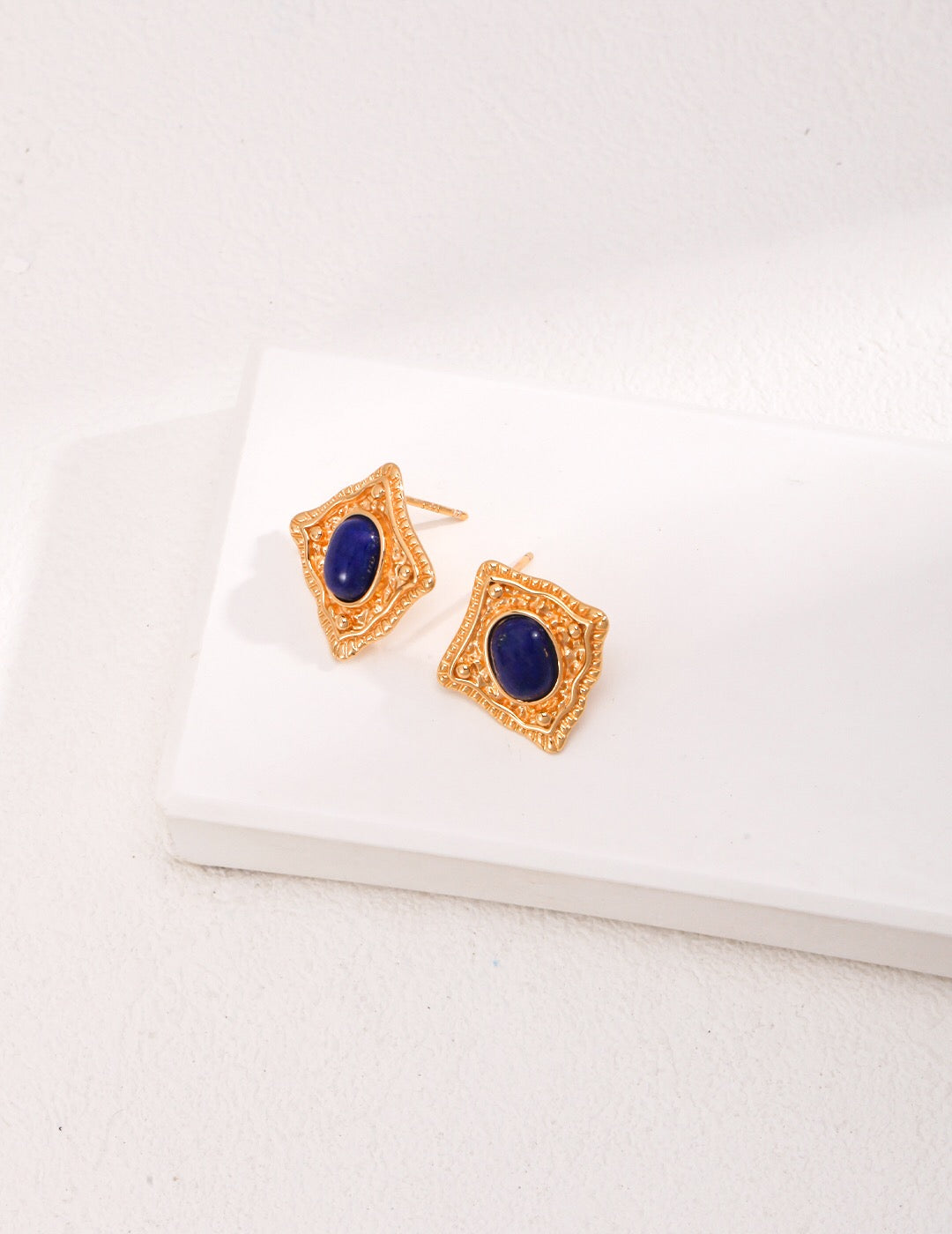 Handmade Lapis Lazuli and Carnelian stud earrings with gold vermeil setting, showcasing vibrant colors and elegant design.