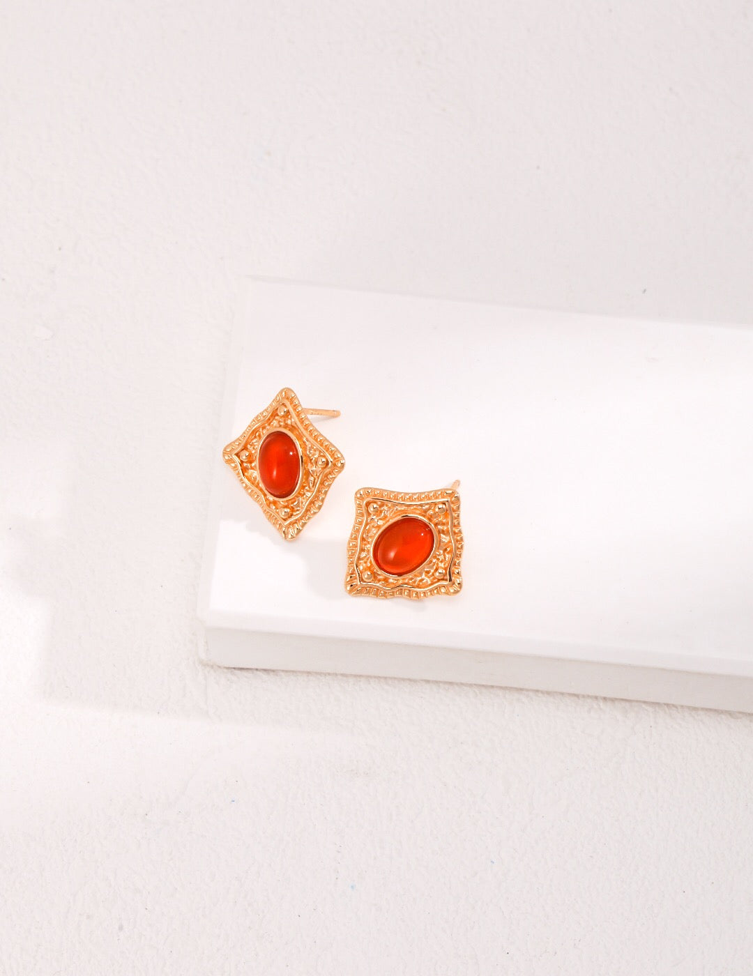 Handmade Lapis Lazuli and Carnelian stud earrings with gold vermeil setting, showcasing vibrant colors and elegant design.