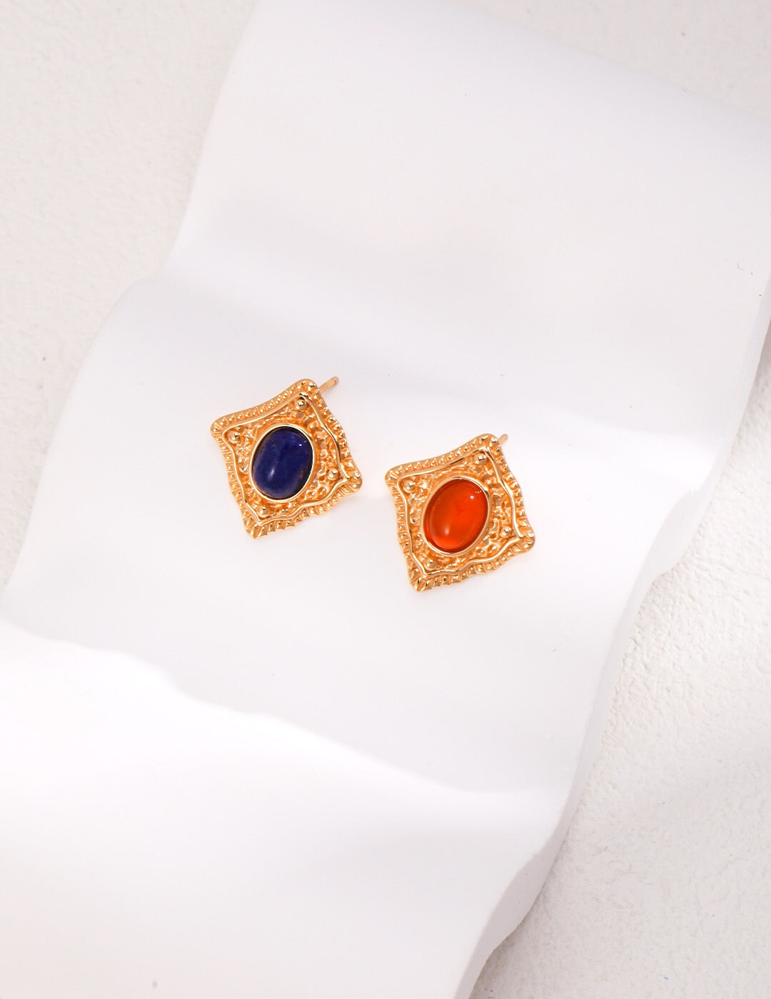 Handmade Lapis Lazuli and Carnelian stud earrings with gold vermeil setting, showcasing vibrant colors and elegant design.