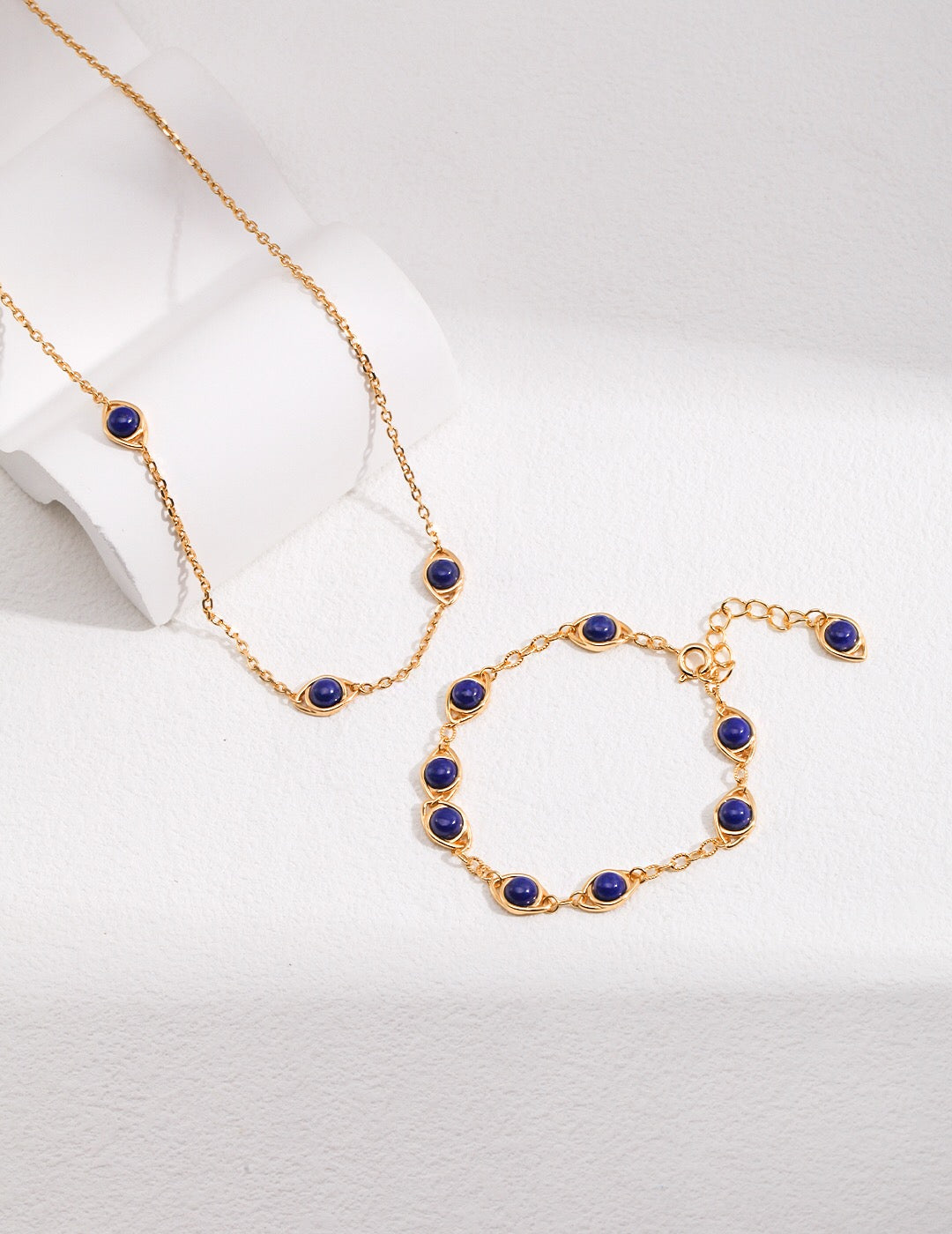 Handmade adjustable bracelet featuring Lapis Lazuli and Tigers Eye stones with gold vermeil accents, elegantly displayed on a soft surface.