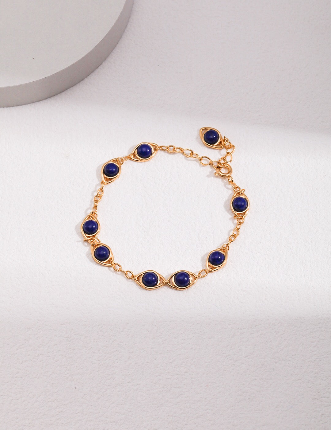 Handmade adjustable bracelet featuring Lapis Lazuli and Tigers Eye stones with gold vermeil accents, elegantly displayed on a soft surface.