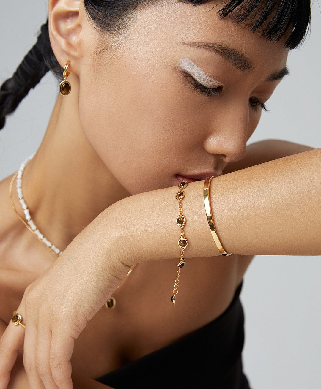 Handmade adjustable bracelet featuring Lapis Lazuli and Tigers Eye stones with gold vermeil accents, elegantly displayed on a soft surface.