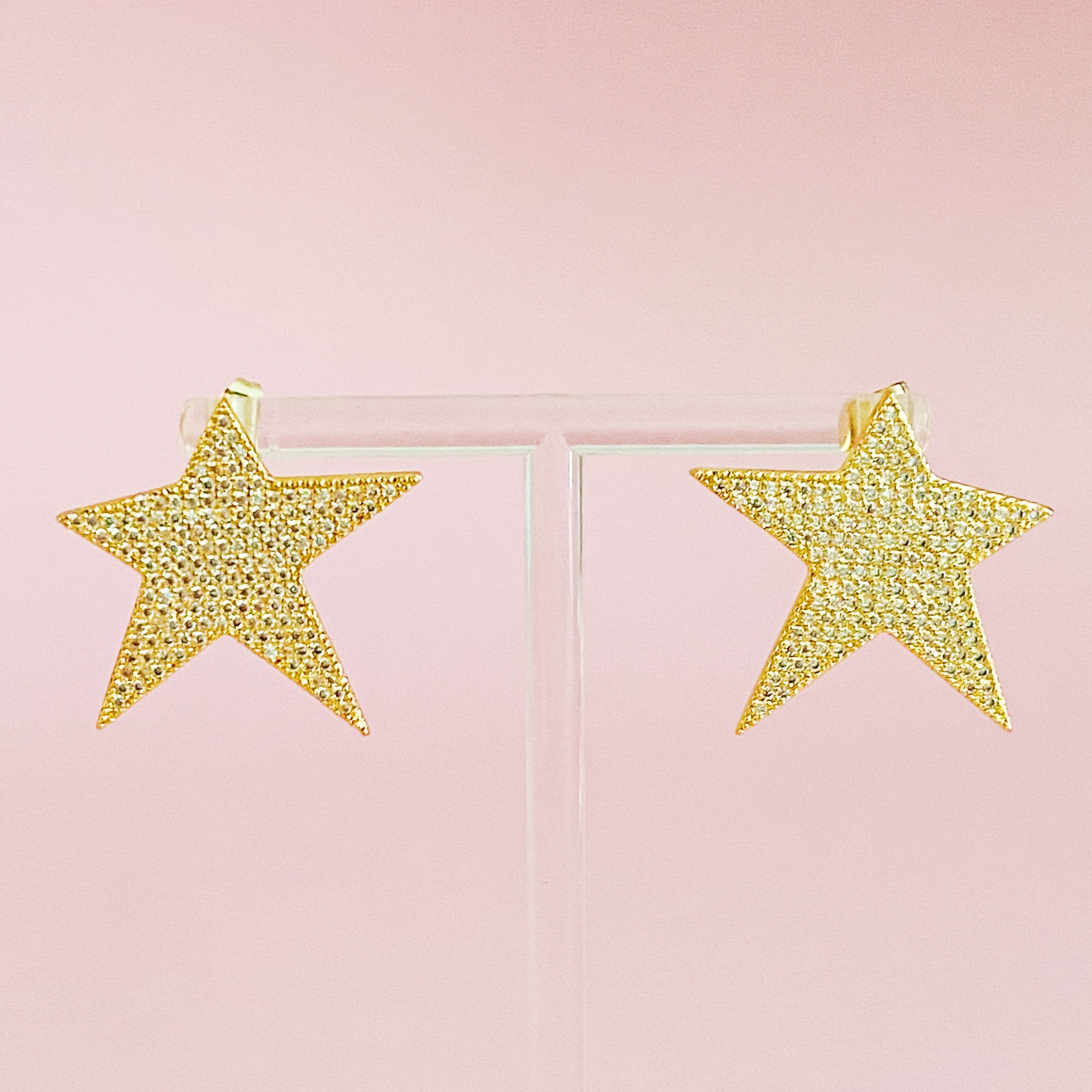 Lara Land Star Earrings featuring sparkling cubic zirconia in a classic star shape, elegantly displayed against a soft background.