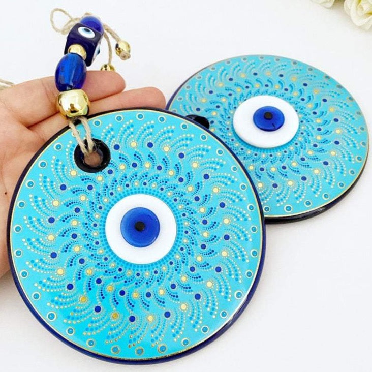 Large blue evil eye wall hanging made of handmade glass, featuring unique fused glass beads, perfect for home decoration.