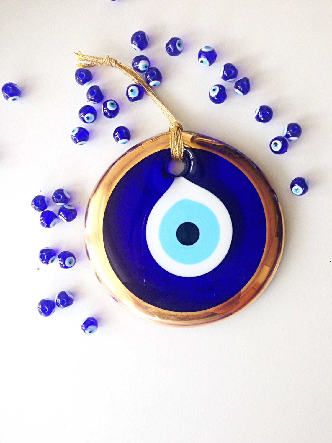 Large Gold Evil Eye Bead, 13cm wall hanging with blue rope, handmade unique design for home decor.