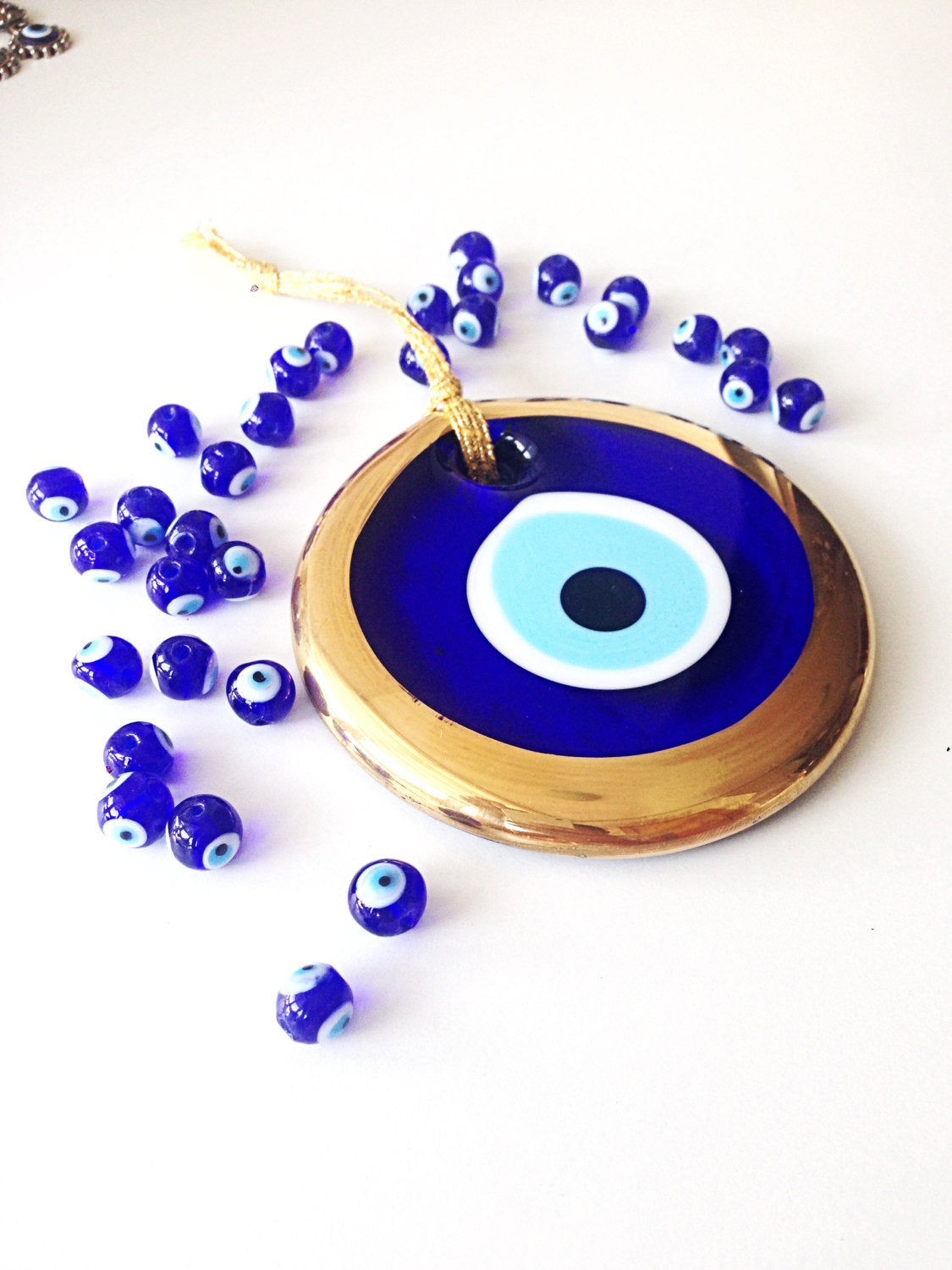 Large Gold Evil Eye Bead, 13cm wall hanging with blue rope, handmade unique design for home decor.