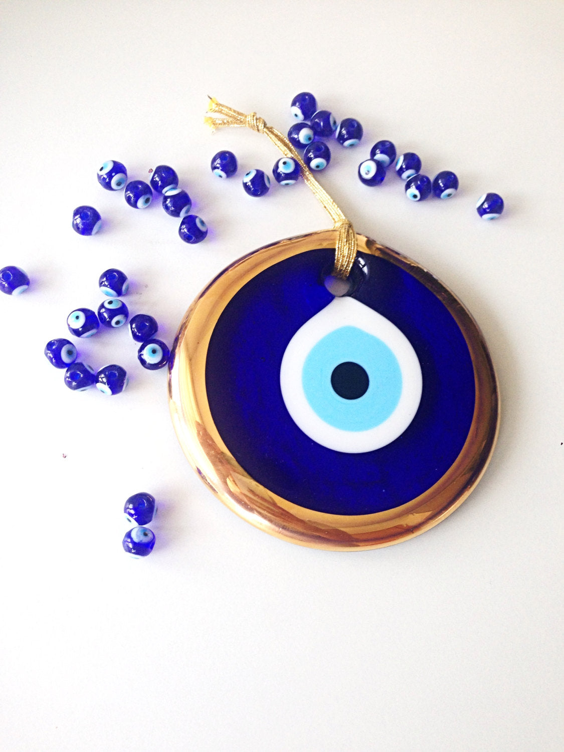 Large Gold Evil Eye Bead, 13cm wall hanging with blue rope, handmade unique design for home decor.