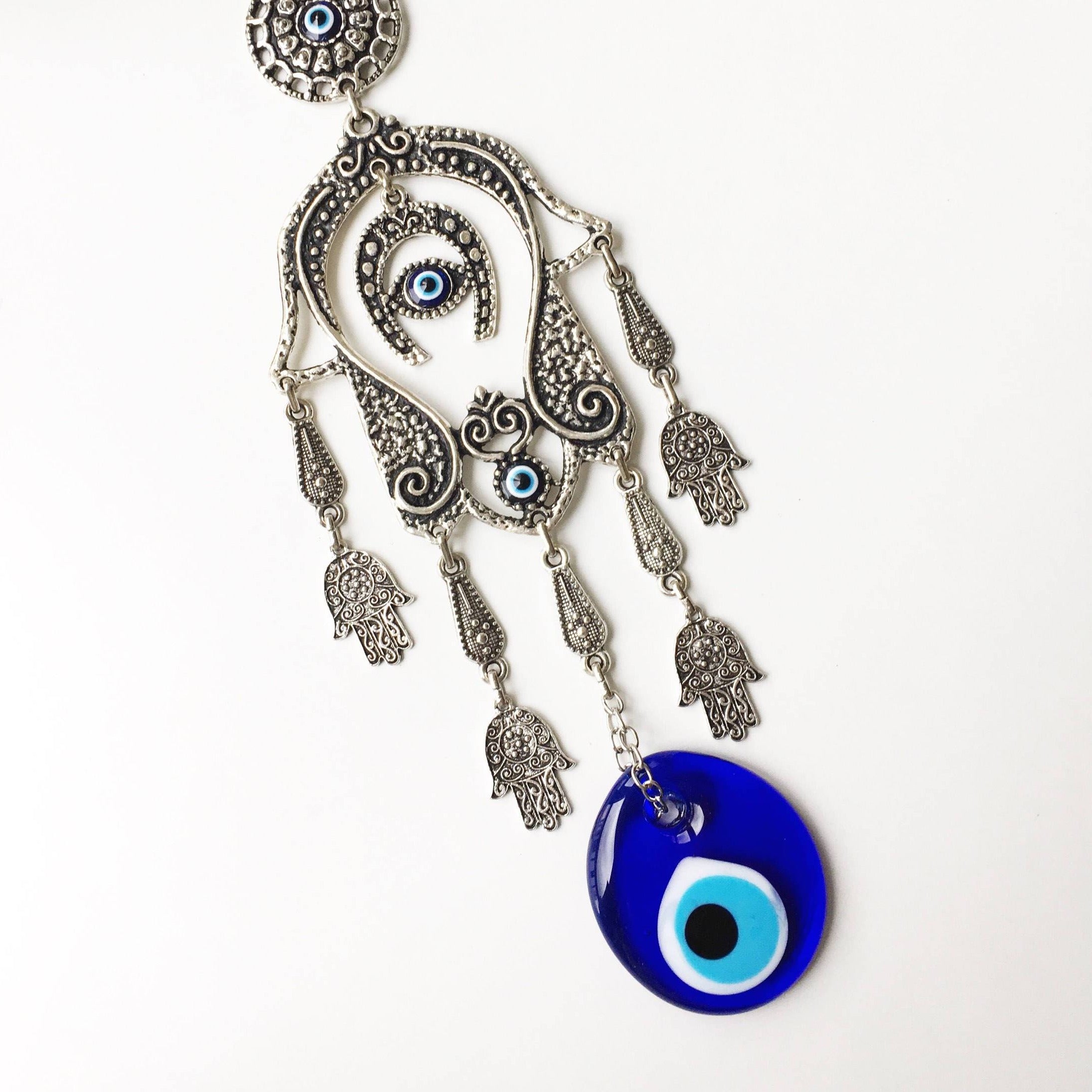 Large Hamsa Evil Eye Wall Hanging featuring a metal Hamsa hand, glass evil eye bead, tiny Hamsa metals, and a horseshoe charm, beautifully crafted for home decor.