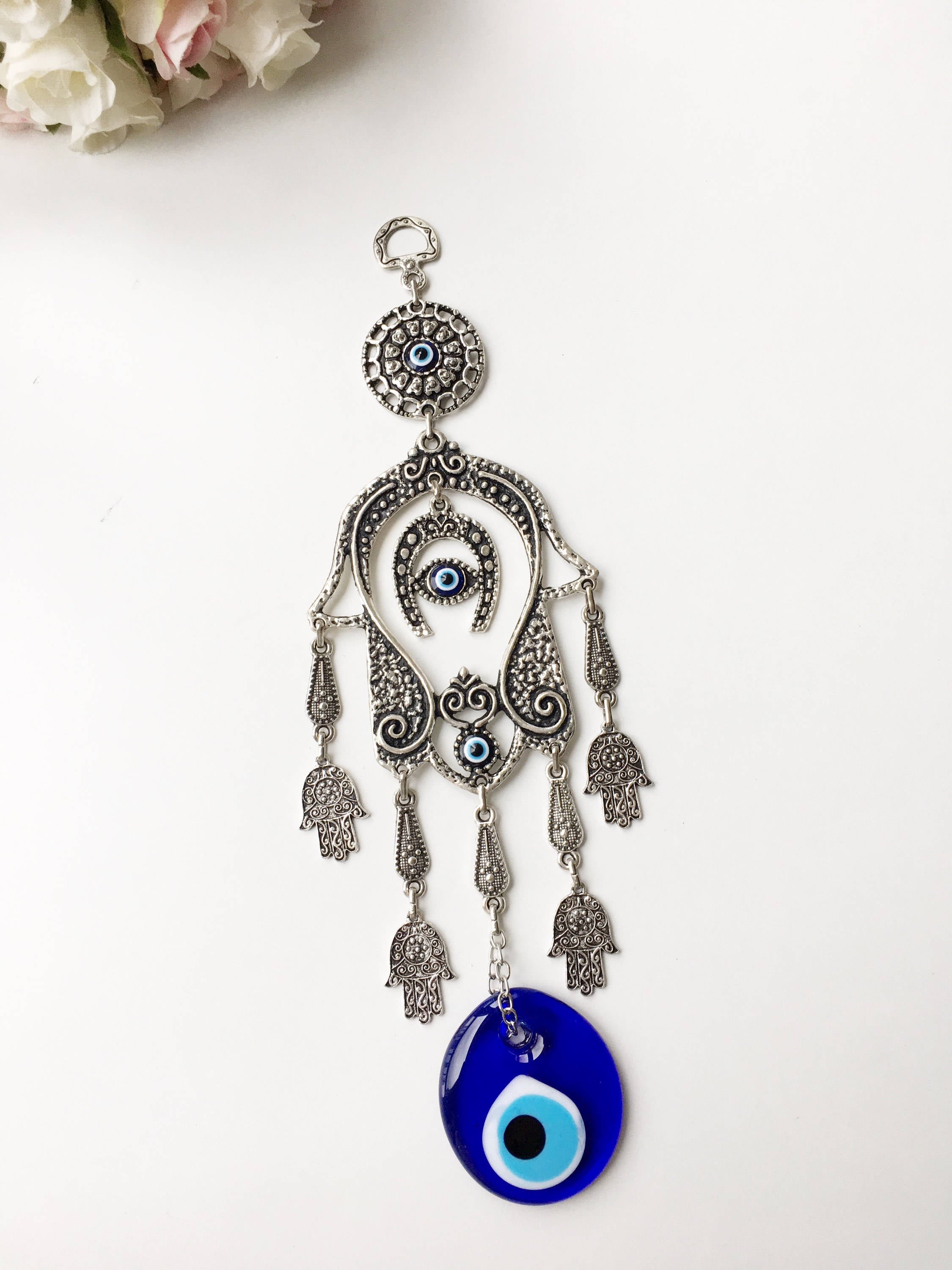 Large Hamsa Evil Eye Wall Hanging featuring a metal Hamsa hand, glass evil eye bead, tiny Hamsa metals, and a horseshoe charm, beautifully crafted for home decor.