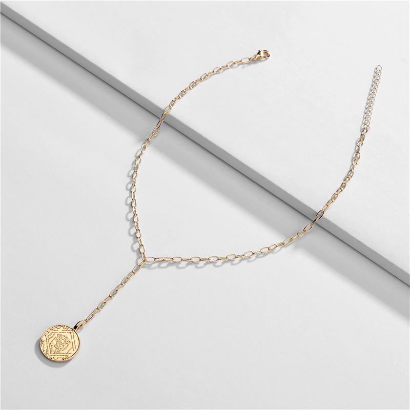 Elegant Gold Coin Lariat Necklace featuring a delicate link chain and a beautiful gold coin pendant, perfect for layering and enhancing any outfit.