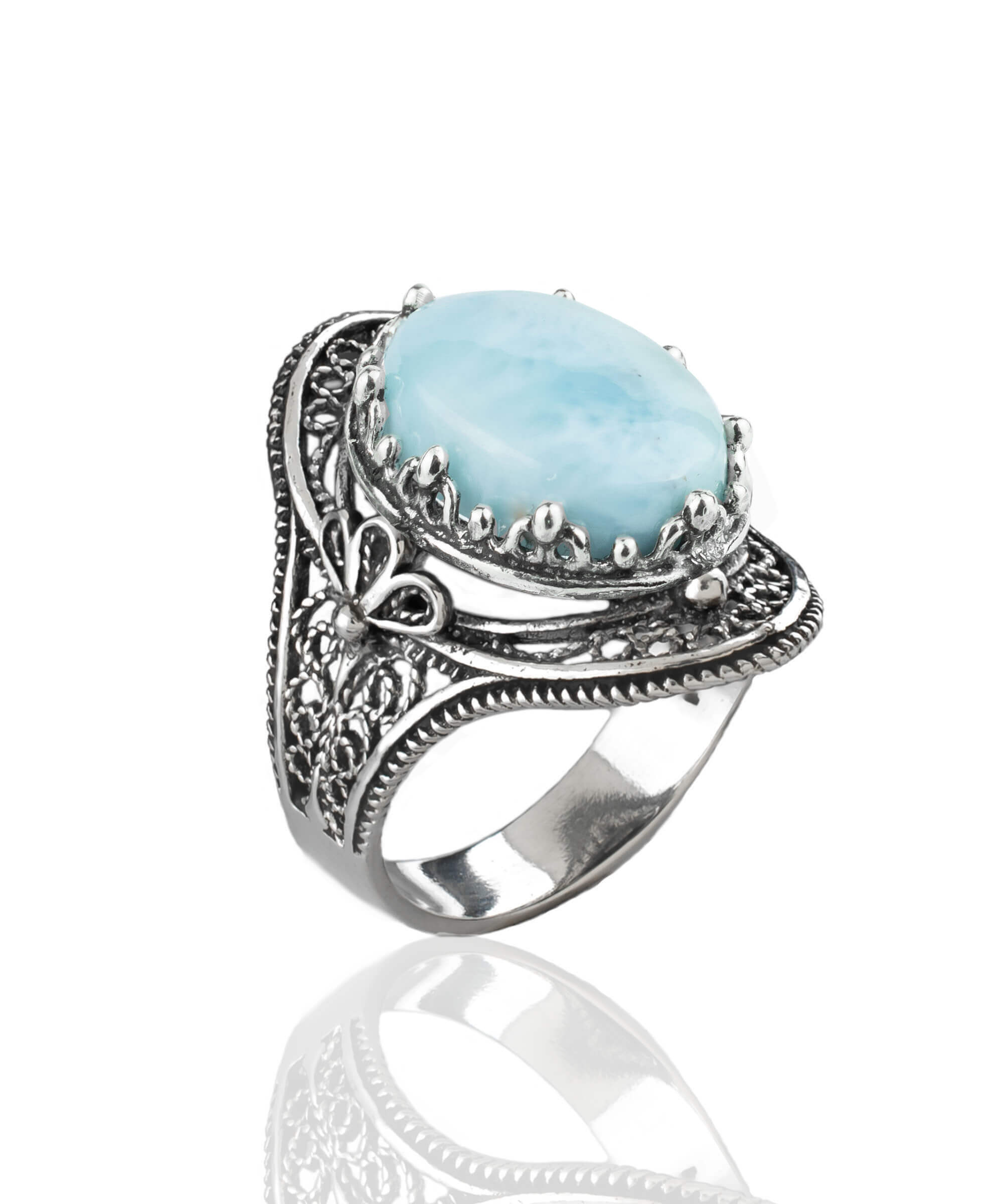 A stunning handmade silver statement ring featuring a polished larimar gemstone in an intricate filigree design, perfect for any occasion.