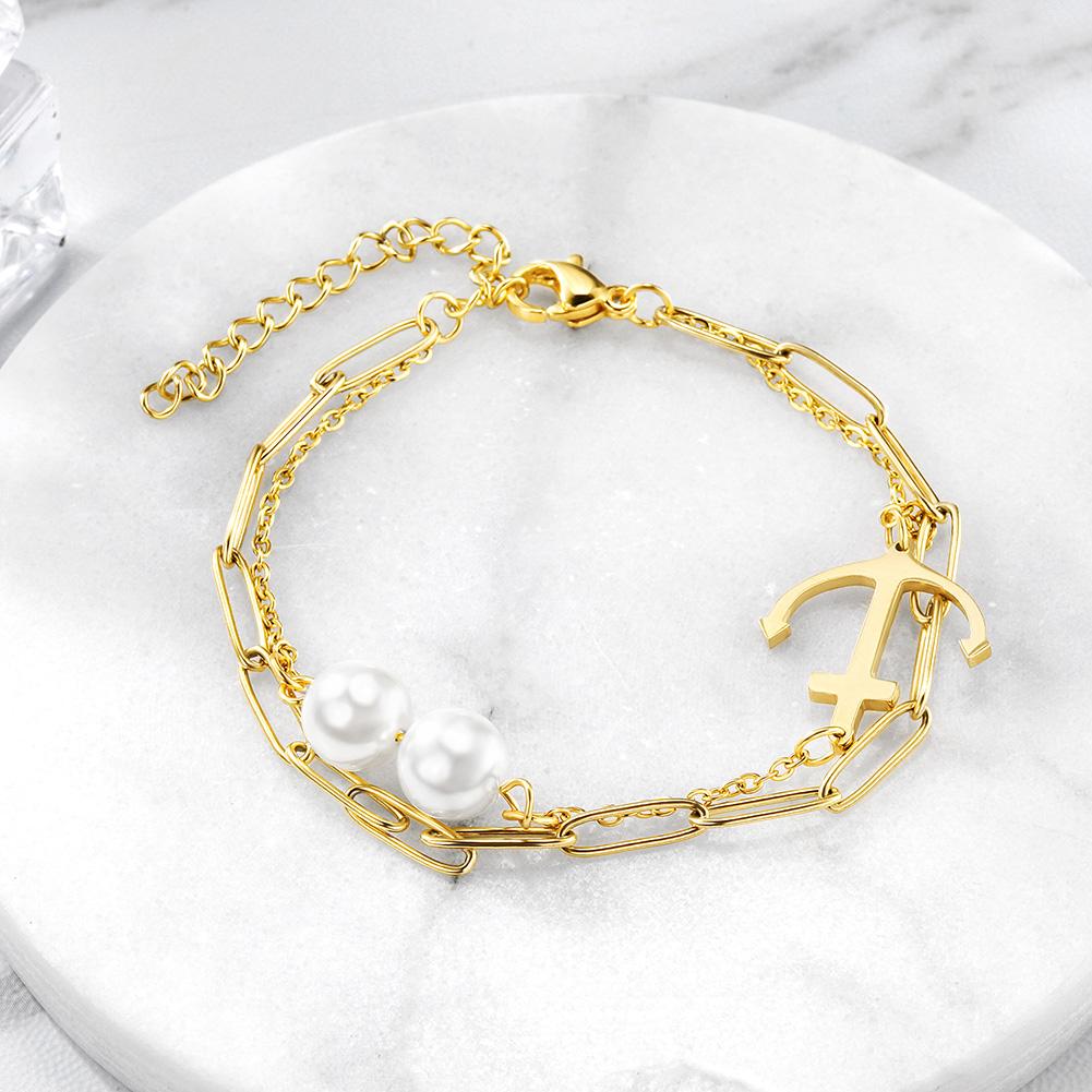 Layered Anchor Pearl Bracelet featuring 316L surgical stainless steel and 14K gold PVD plating, showcasing an elegant layered design.