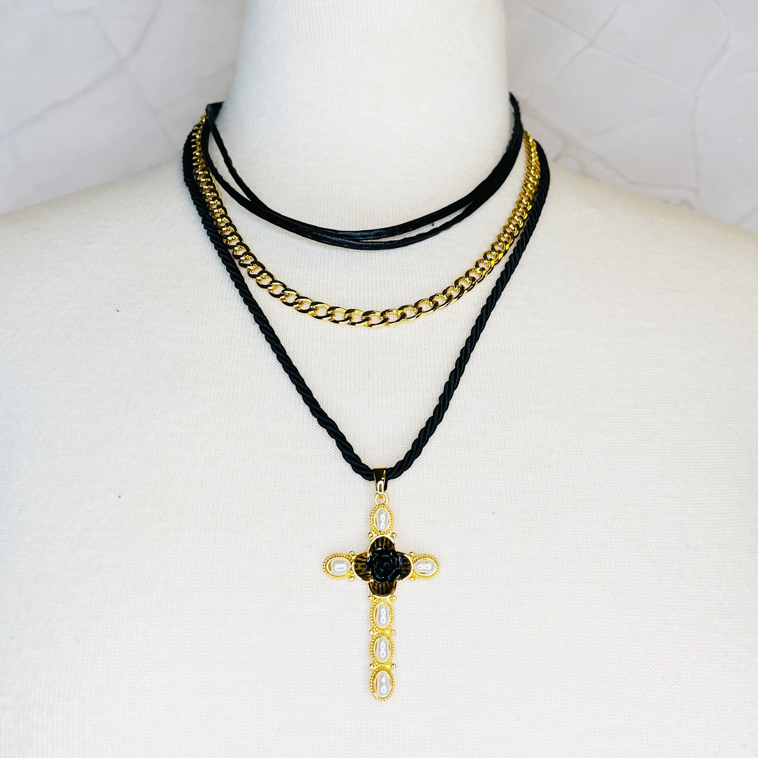 Layered Black Rose Cross Necklace featuring vegan leather and a stylish cross pendant, showcasing three layers with an extender.