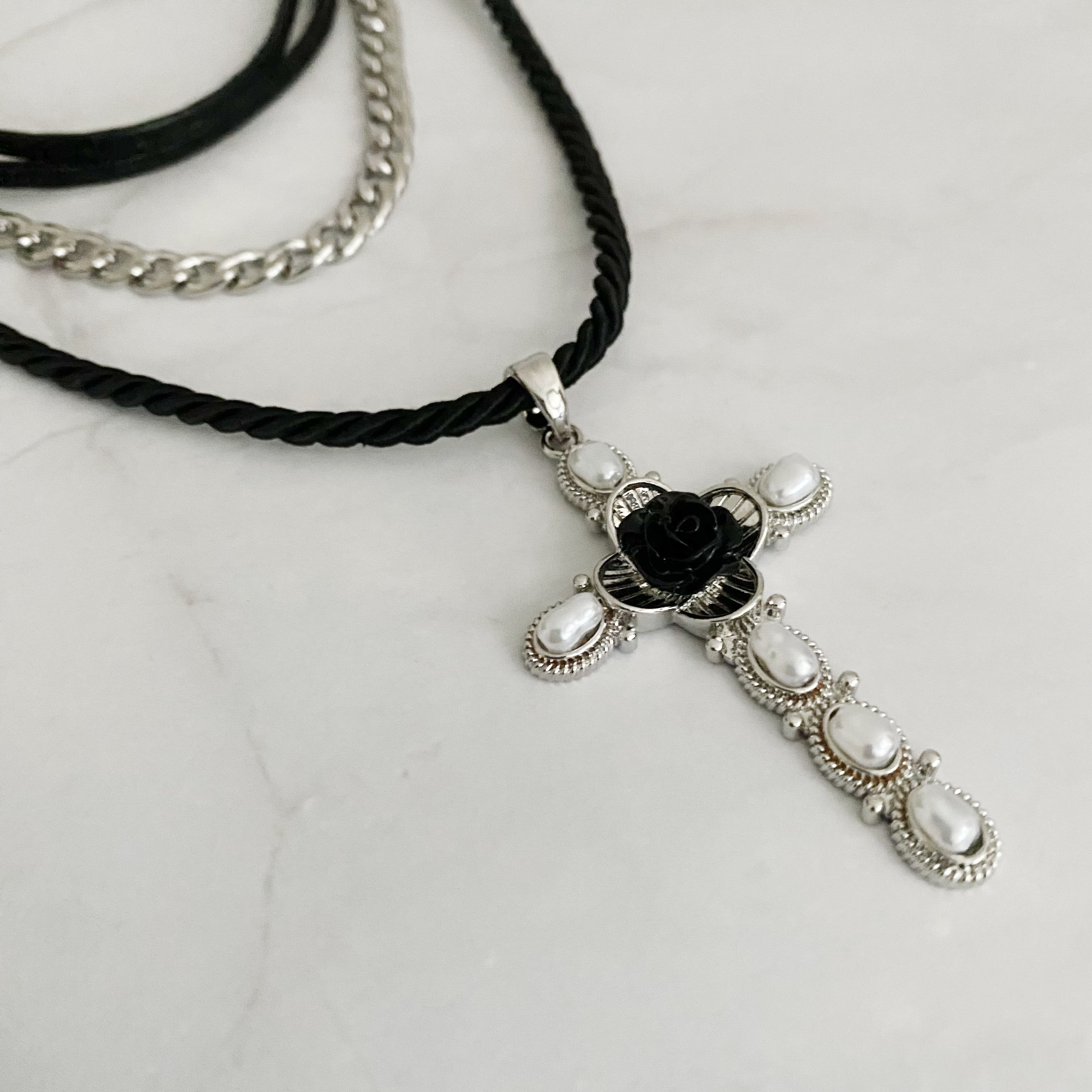 Layered Black Rose Cross Necklace featuring vegan leather and a stylish cross pendant, showcasing three layers with an extender.