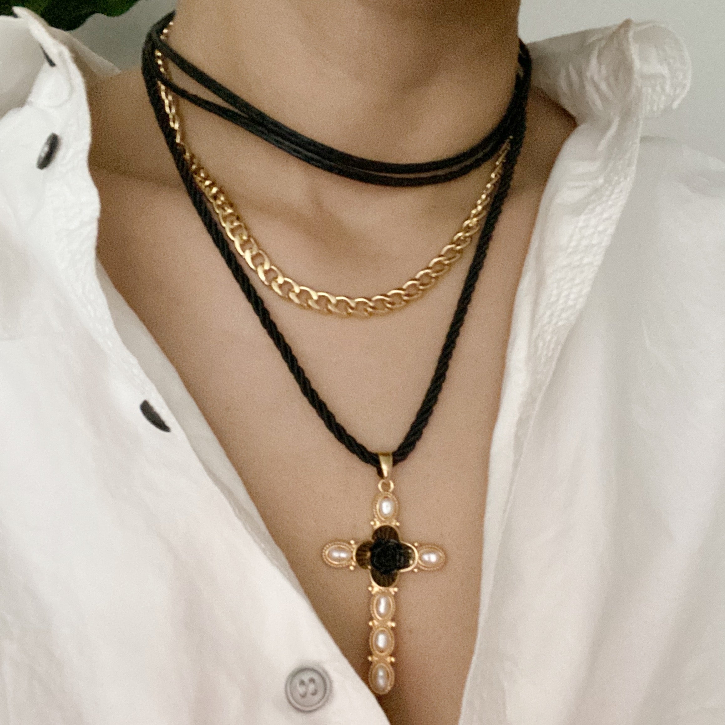 Layered Black Rose Cross Necklace featuring vegan leather and a stylish cross pendant, showcasing three layers with an extender.