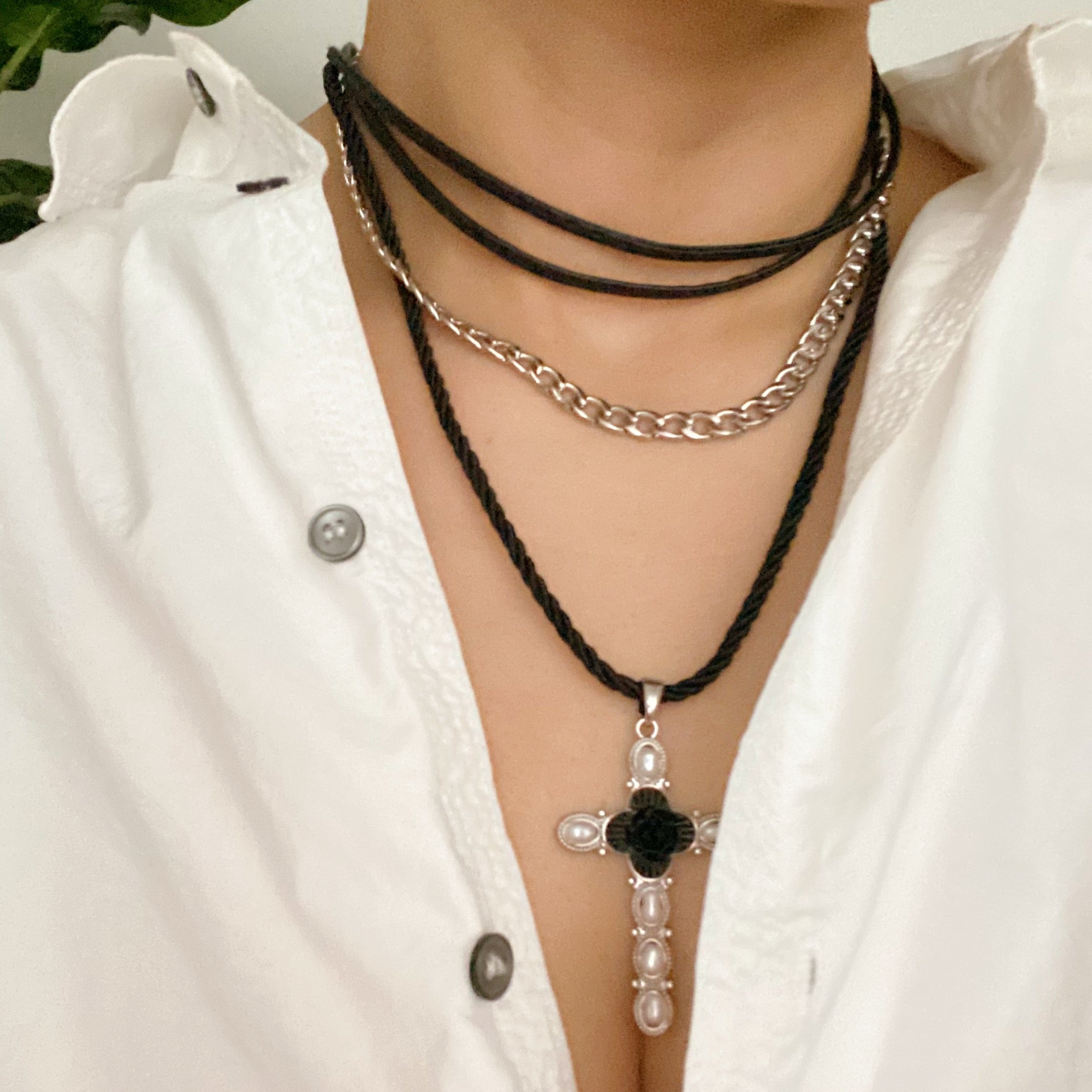 Layered Black Rose Cross Necklace featuring vegan leather and a stylish cross pendant, showcasing three layers with an extender.