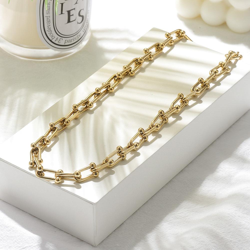 Le Cheval Necklace featuring horse shoe links in stainless steel, elegantly displayed in a gift box.