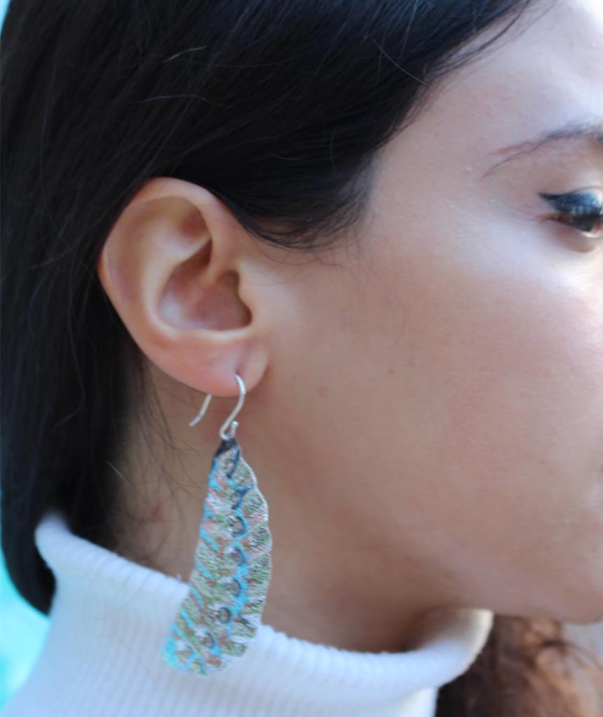 Elegant Leaf Statement Earrings in brass with intricate tribal design, available in gold and silver.