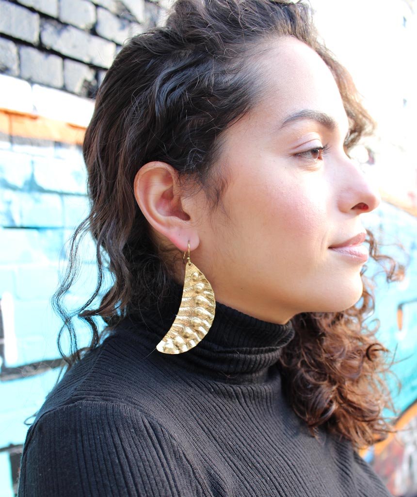 Elegant Leaf Statement Earrings in brass with intricate tribal design, available in gold and silver.