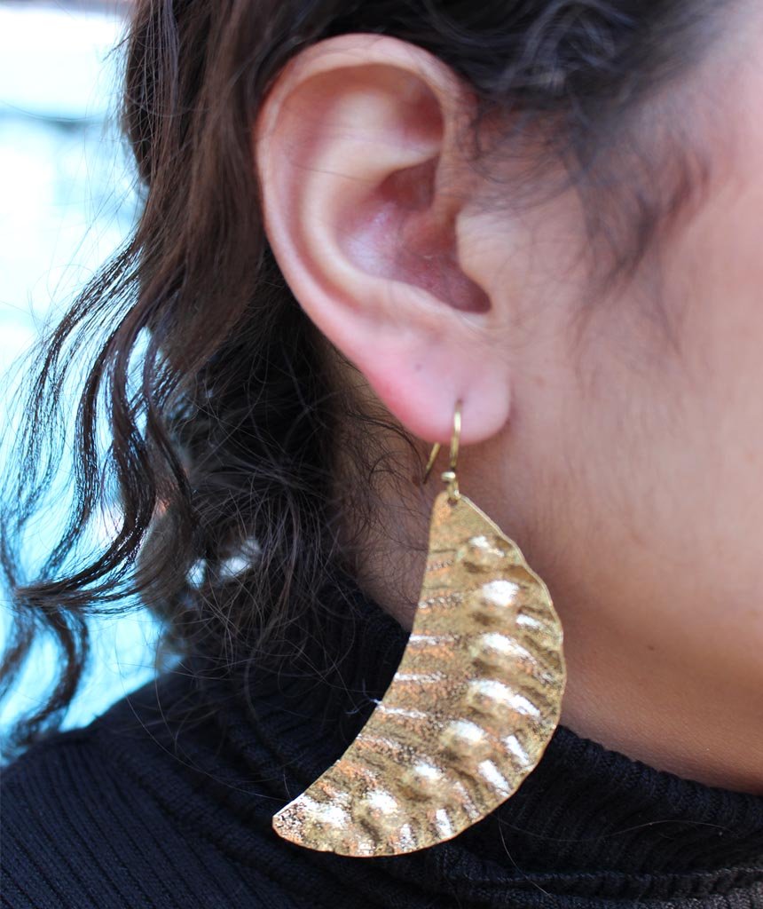 Elegant Leaf Statement Earrings in brass with intricate tribal design, available in gold and silver.