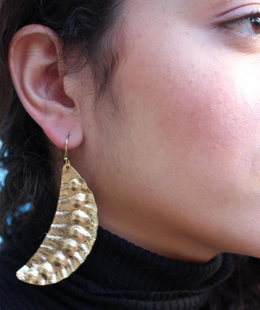 Elegant Leaf Statement Earrings in brass with intricate tribal design, available in gold and silver.