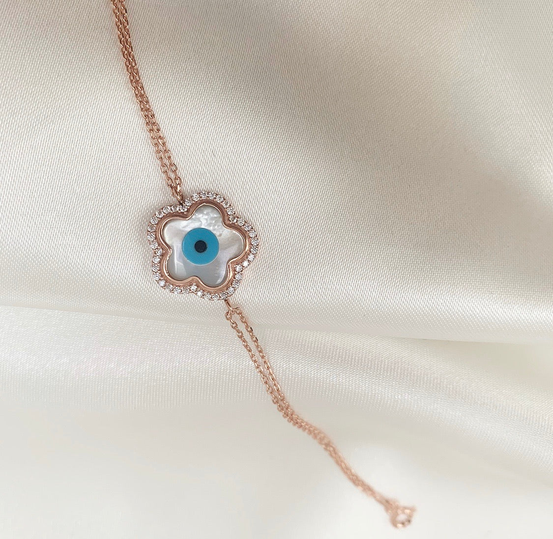 LEAH Bracelet featuring a flower charm with cubic zirconias and an enameled evil eye, crafted in 925 Sterling Silver with rose gold plating.