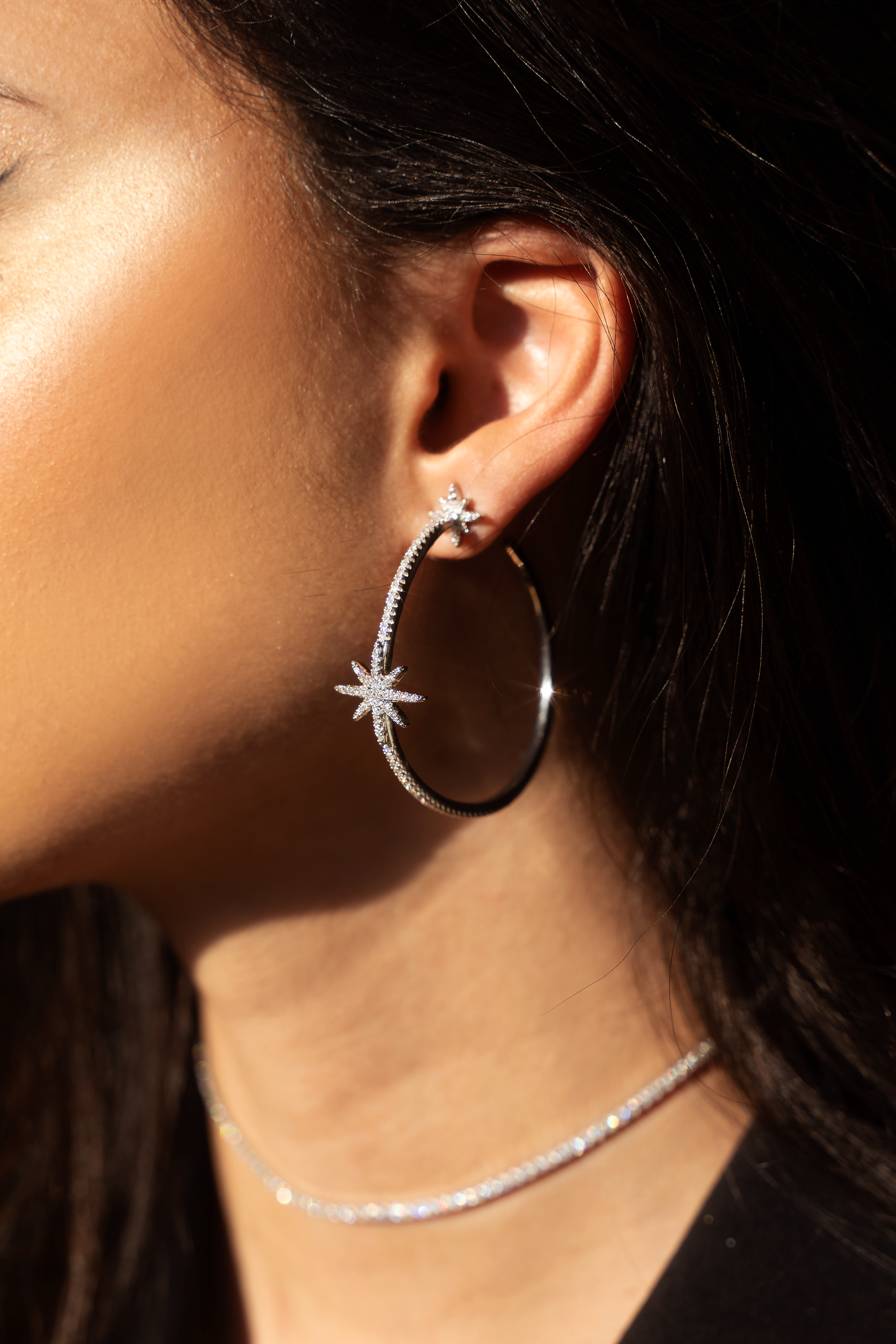 LEILA Hoop Earrings featuring cubic zirconia stars in a stylish c-hoop design, available in silver, gold, and black.