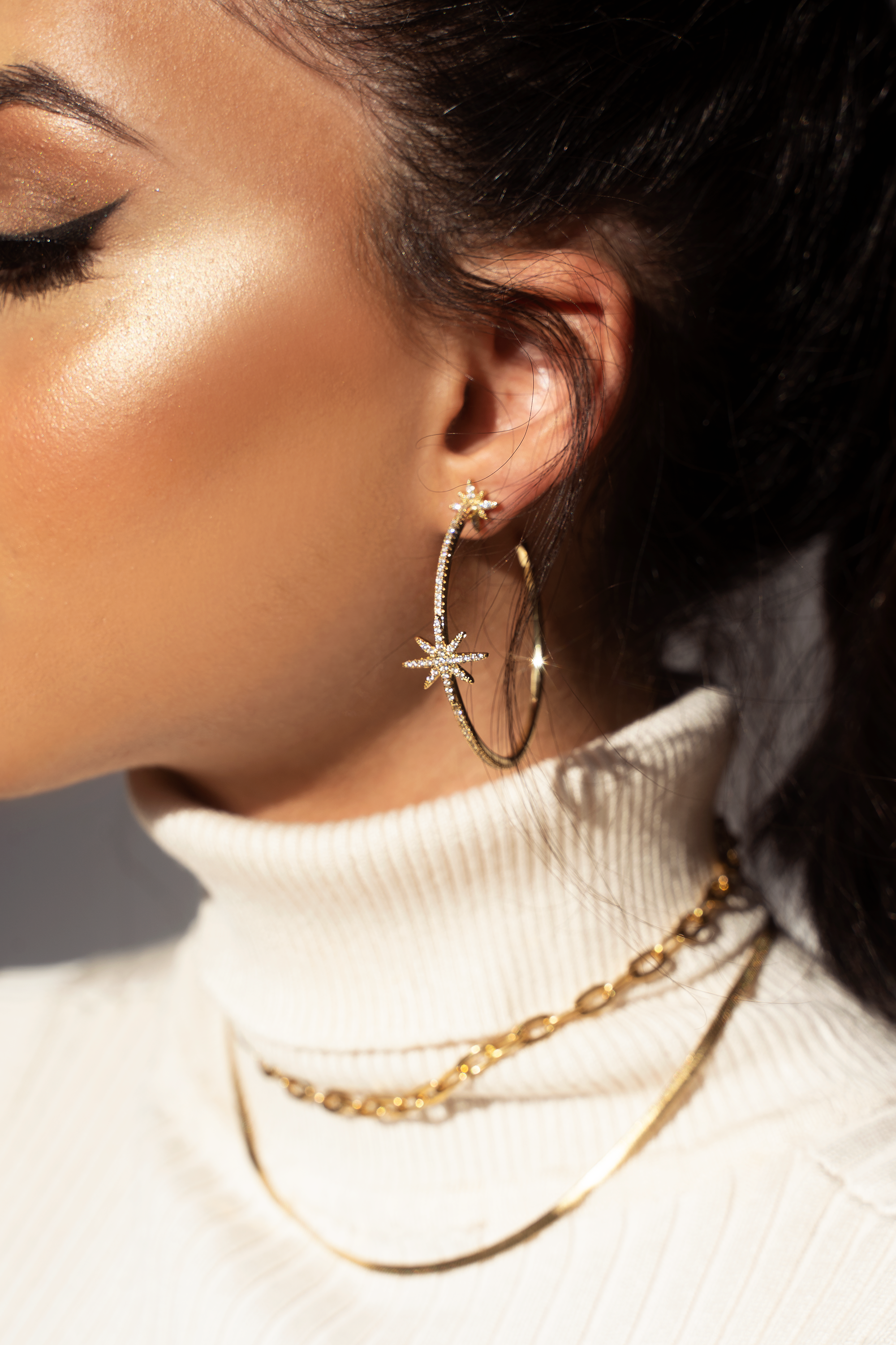 LEILA Hoop Earrings featuring cubic zirconia stars in a stylish c-hoop design, available in silver, gold, and black.