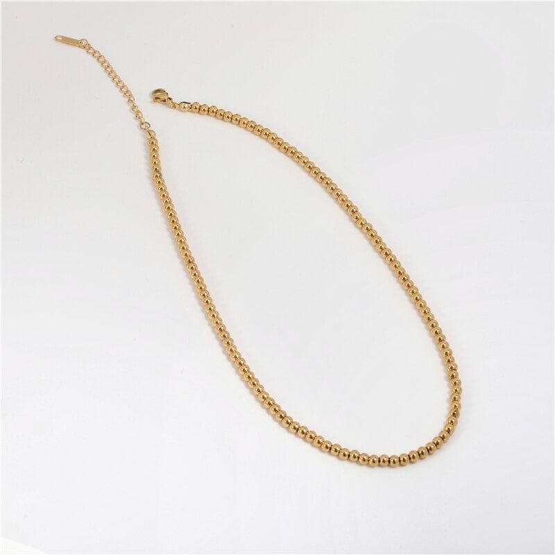 Leonidas Ball Beaded Necklace featuring gold beaded design and stainless steel material, showcasing elegance and durability.