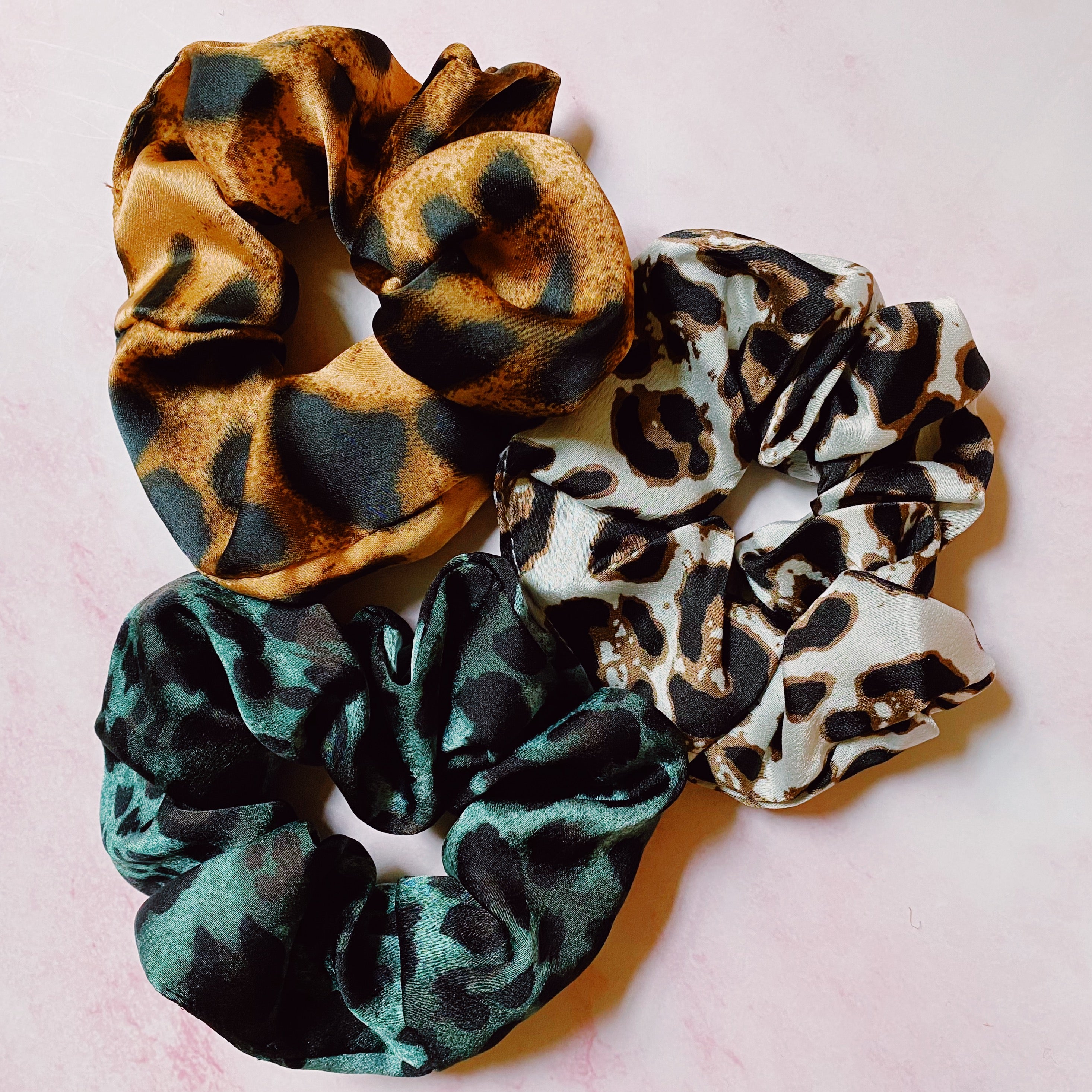 Leopard Satin Scrunch Set of 3 in a clear cello case, showcasing luxurious satin material and trendy leopard patterns.