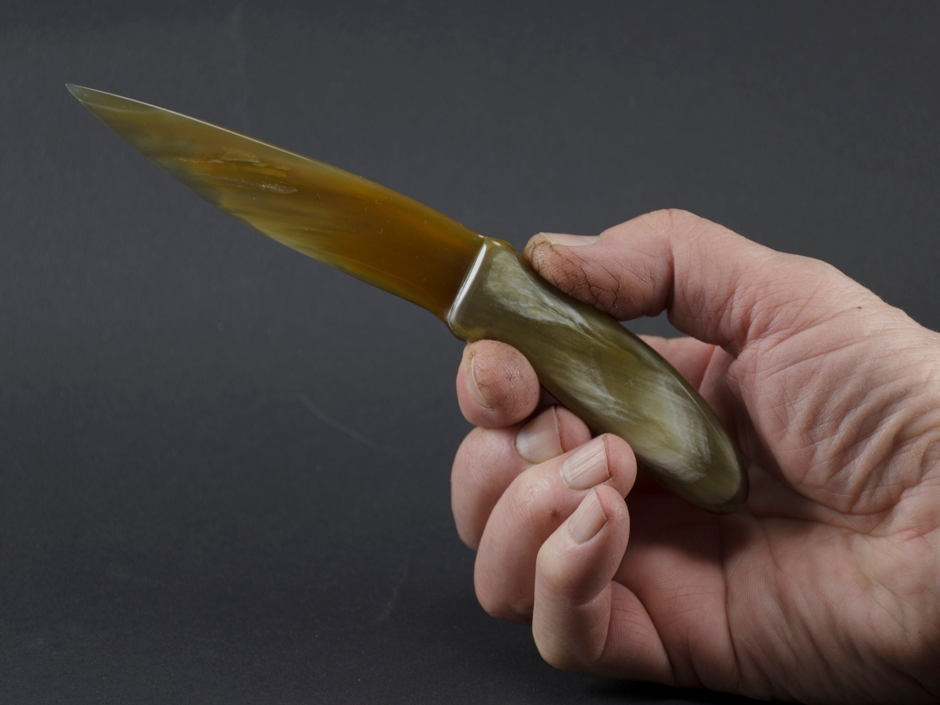 Handmade letter opener crafted from polished cow horn, featuring a sharp blade and elegant design.