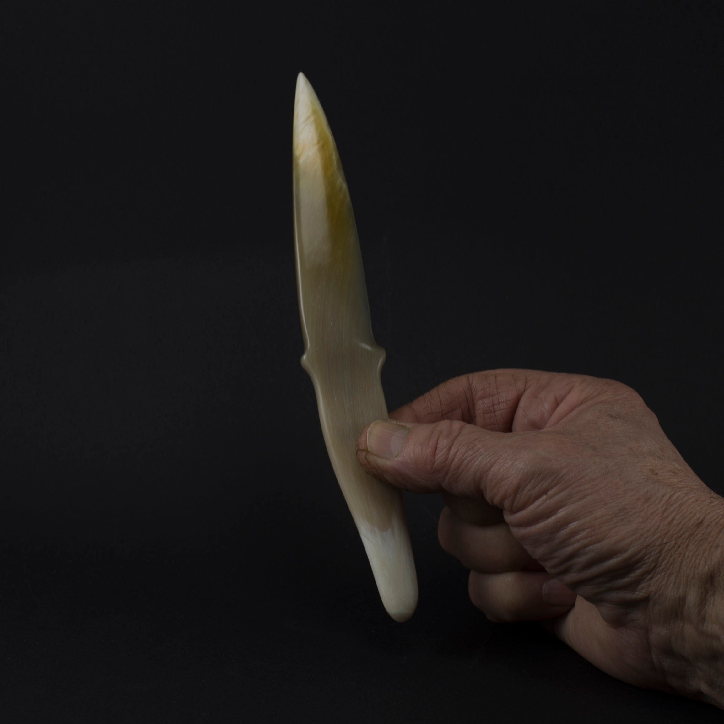 Elegant bull horn letter opener with a sharp, polished blade, showcasing natural patterns and high-gloss finish.