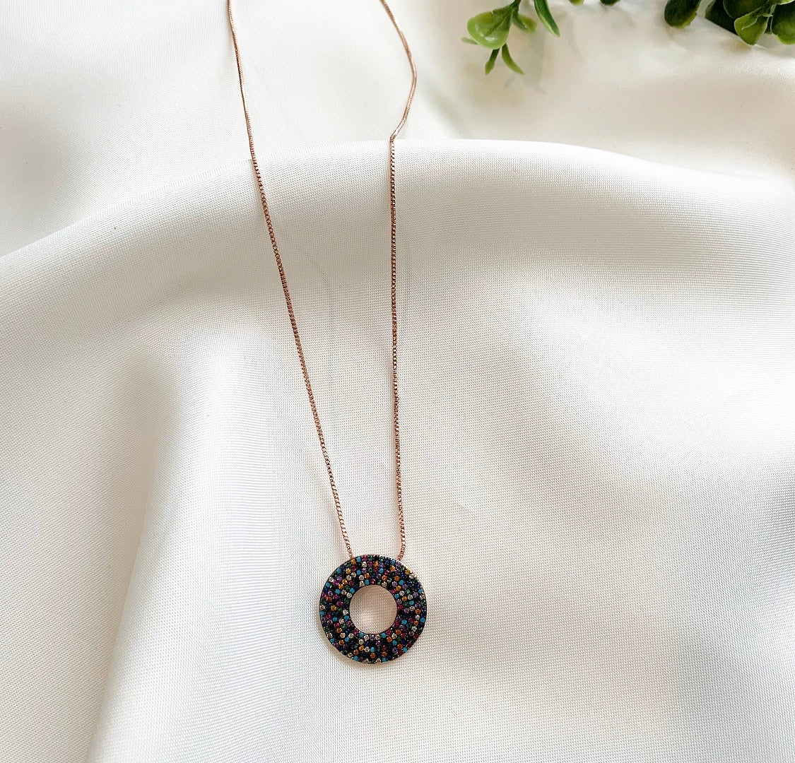 LIA Necklace featuring colorful cubic zirconia stones on a black-finished eternity circle pendant with a 14k rose gold plated cable chain.