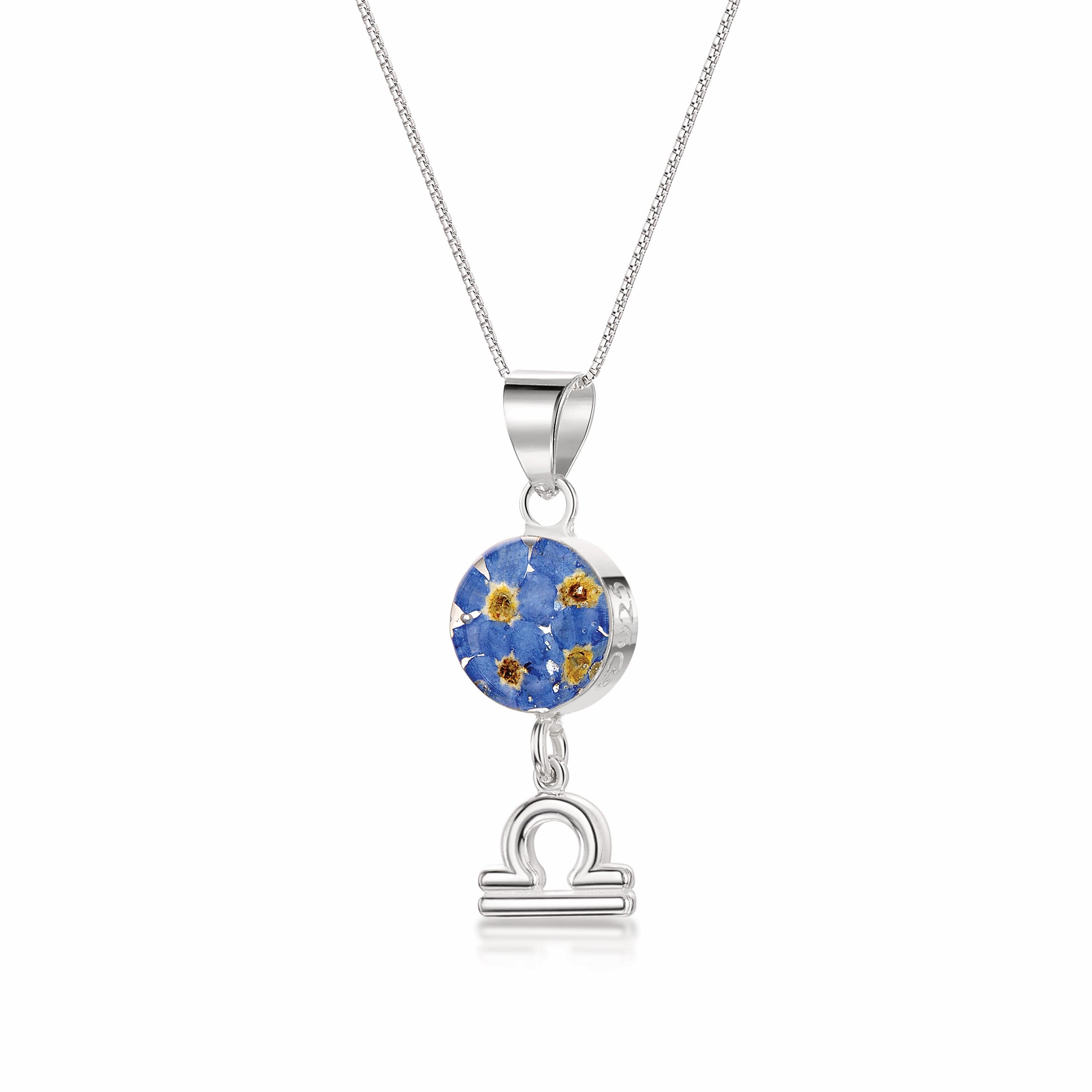 A beautiful Libra Necklace featuring a sterling silver pendant with real preserved flowers and a zodiac charm, showcasing elegance and individuality.