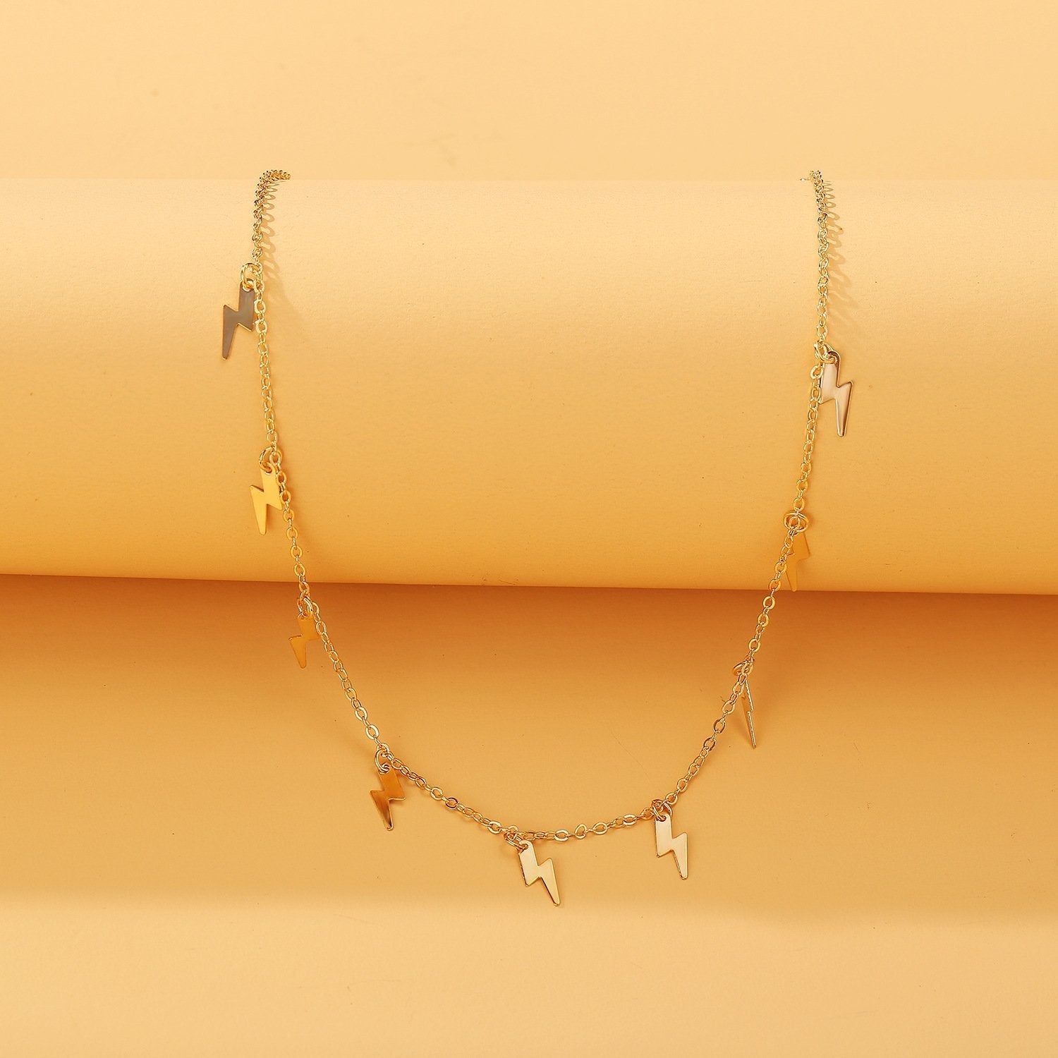 A stunning 18K gold plated Lightning Bolt Necklace featuring a link chain and lobster clasp, elegantly displayed against a soft background.