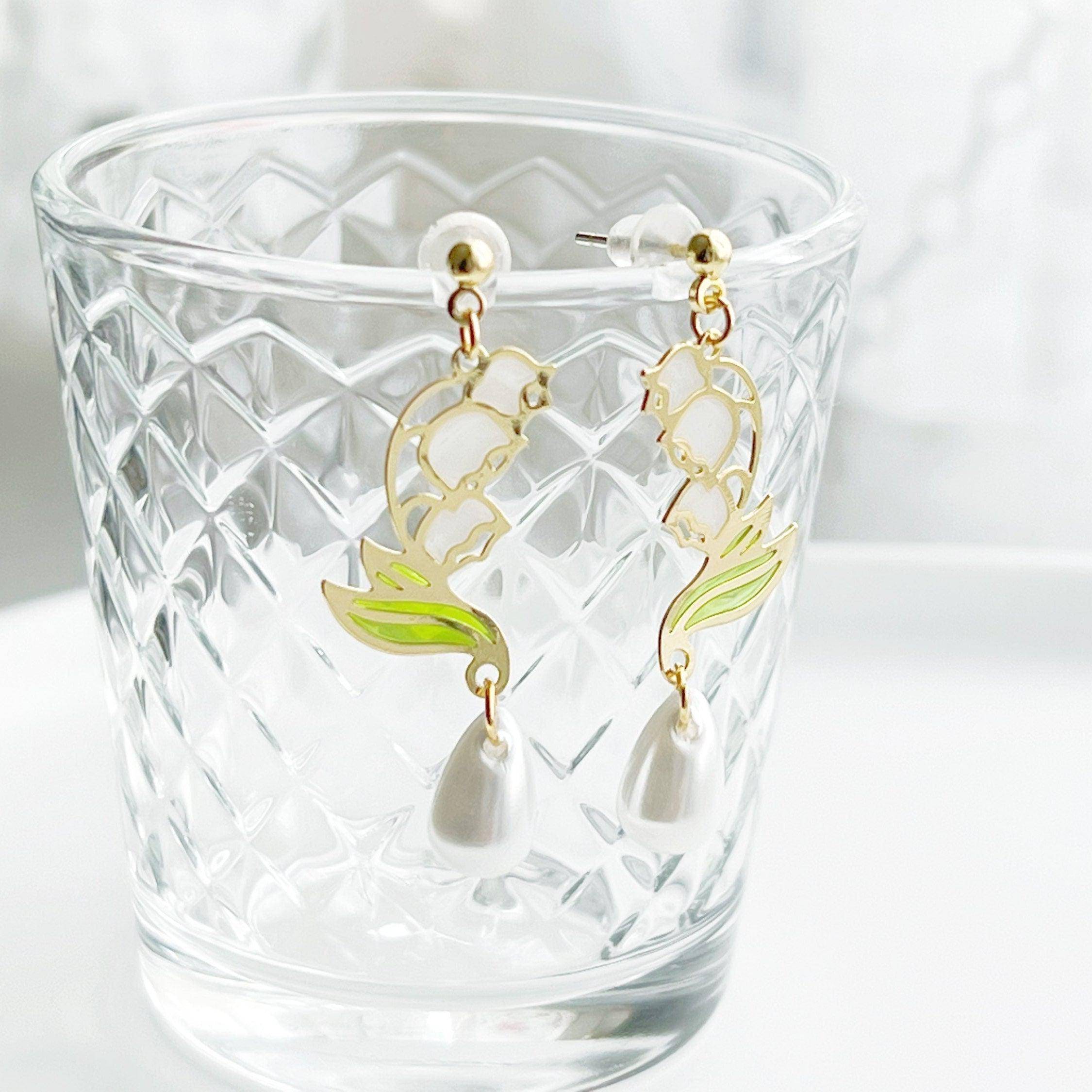 Elegant Lily of the Valley Earrings featuring white bell-shaped flowers, crafted from sterling silver and gold-plated bronze.