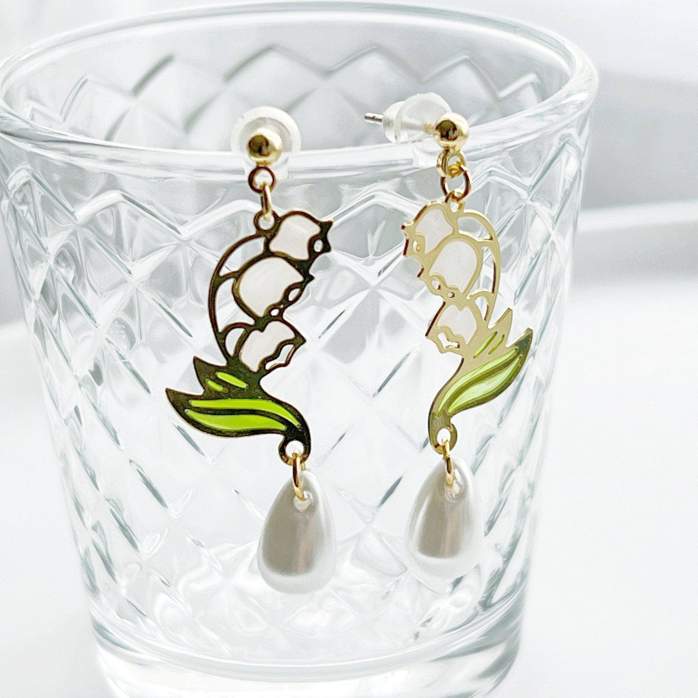 Elegant Lily of the Valley Earrings featuring white bell-shaped flowers, crafted from sterling silver and gold-plated bronze.