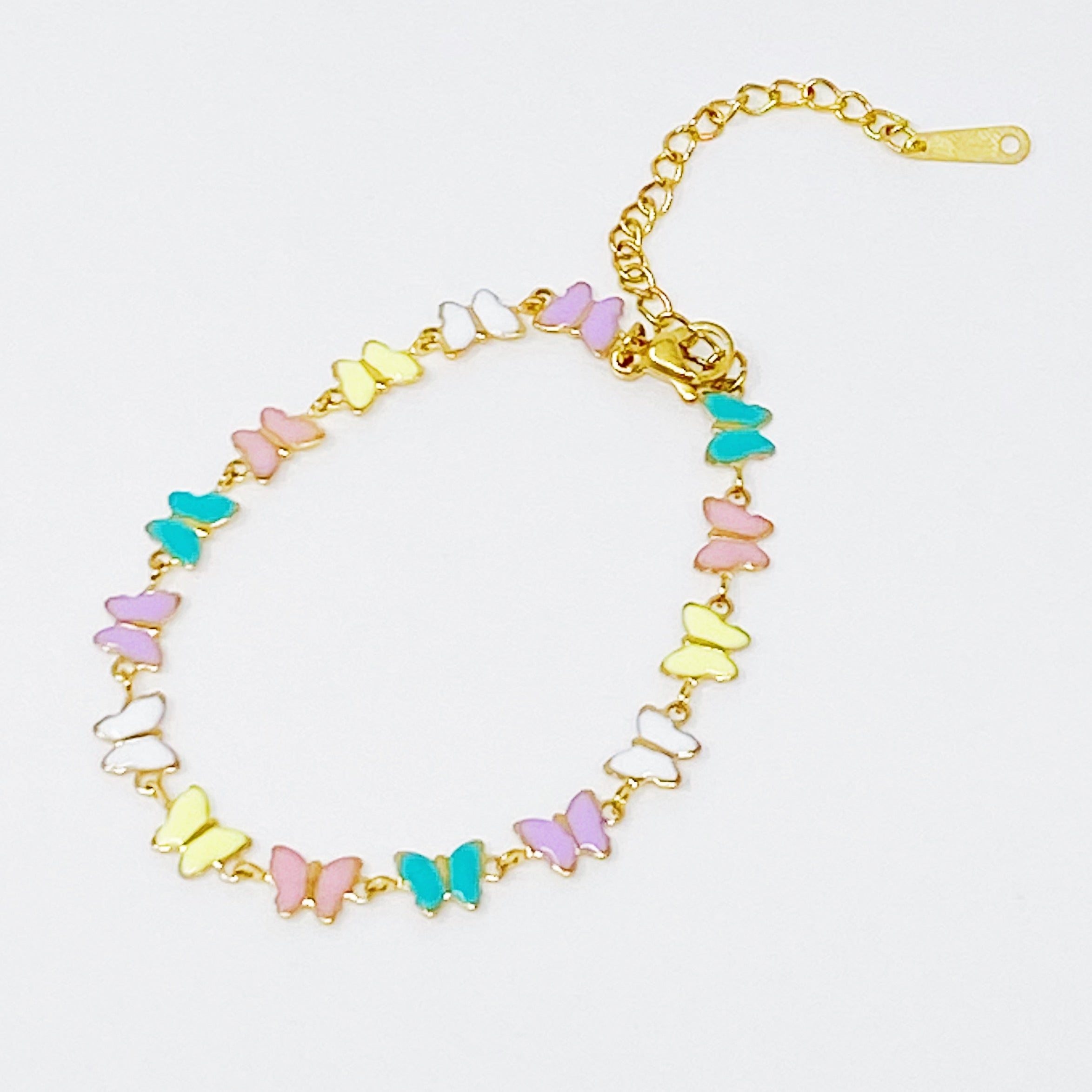 Linked Butterflies Bracelet featuring pastel butterflies and a reversible gold side, elegantly designed with intricate details.