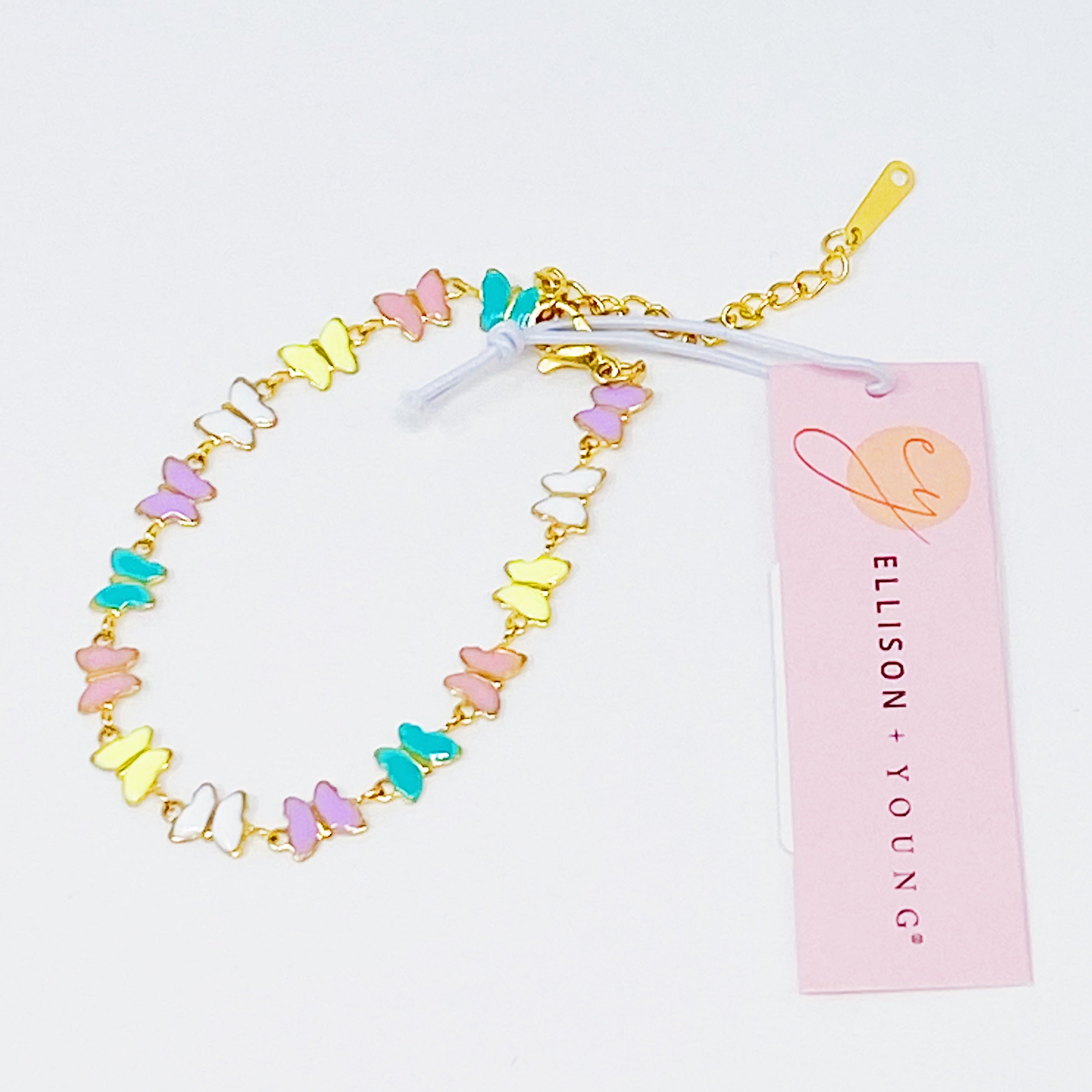 Linked Butterflies Bracelet featuring pastel butterflies and a reversible gold side, elegantly designed with intricate details.