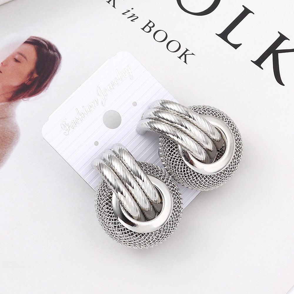 A pair of elegant linking honeycomb earrings made from alloy and steel, showcasing a unique honeycomb design.