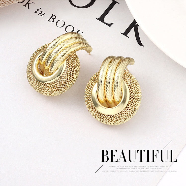 A pair of elegant linking honeycomb earrings made from alloy and steel, showcasing a unique honeycomb design.