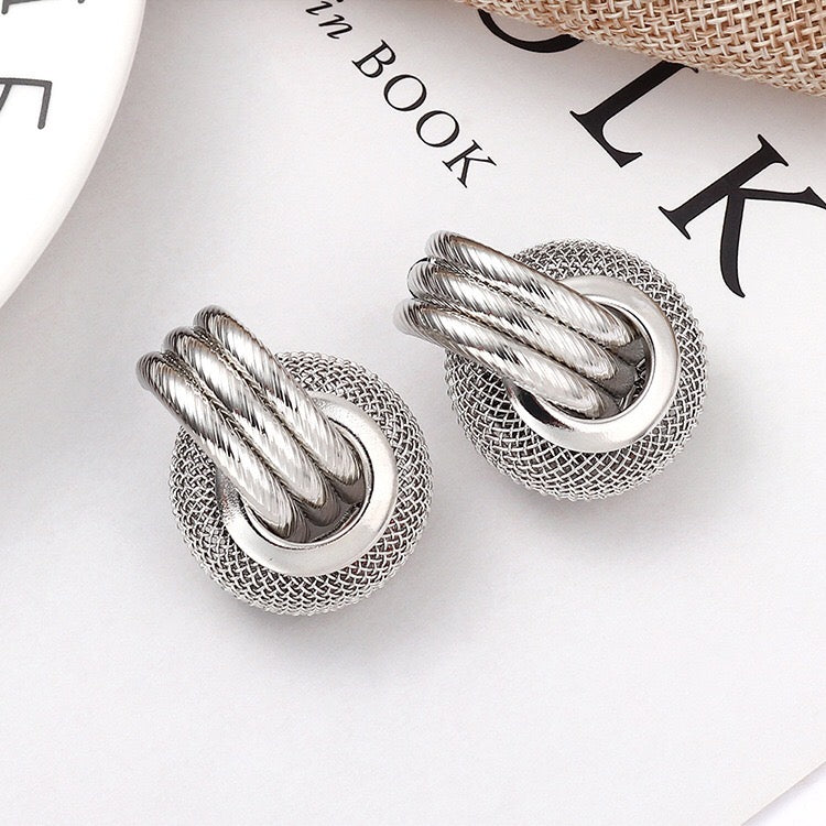 A pair of elegant linking honeycomb earrings made from alloy and steel, showcasing a unique honeycomb design.