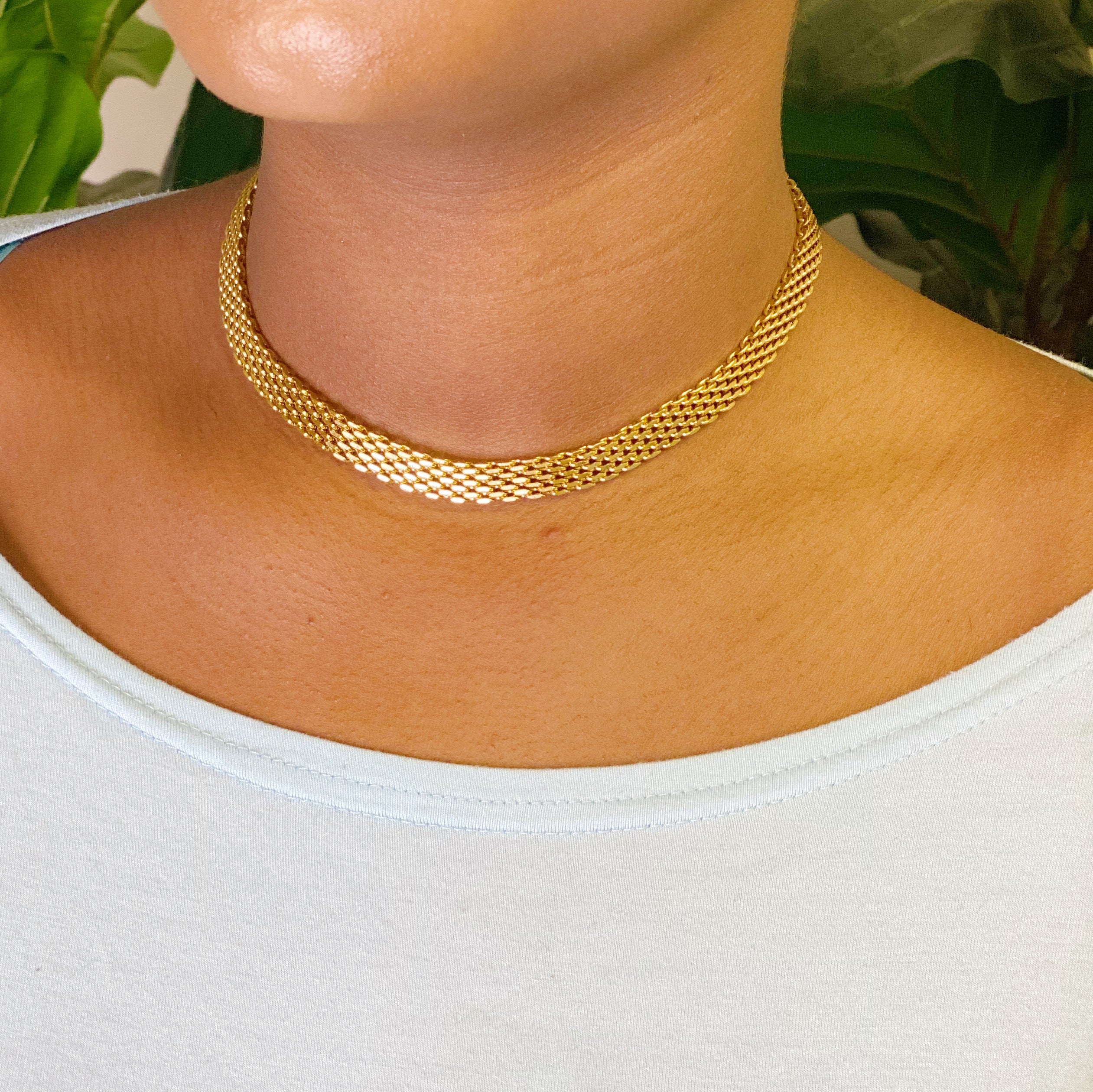 A stylish mesh gold linked necklace with adjustable length, showcasing its elegant design and high-quality finish.