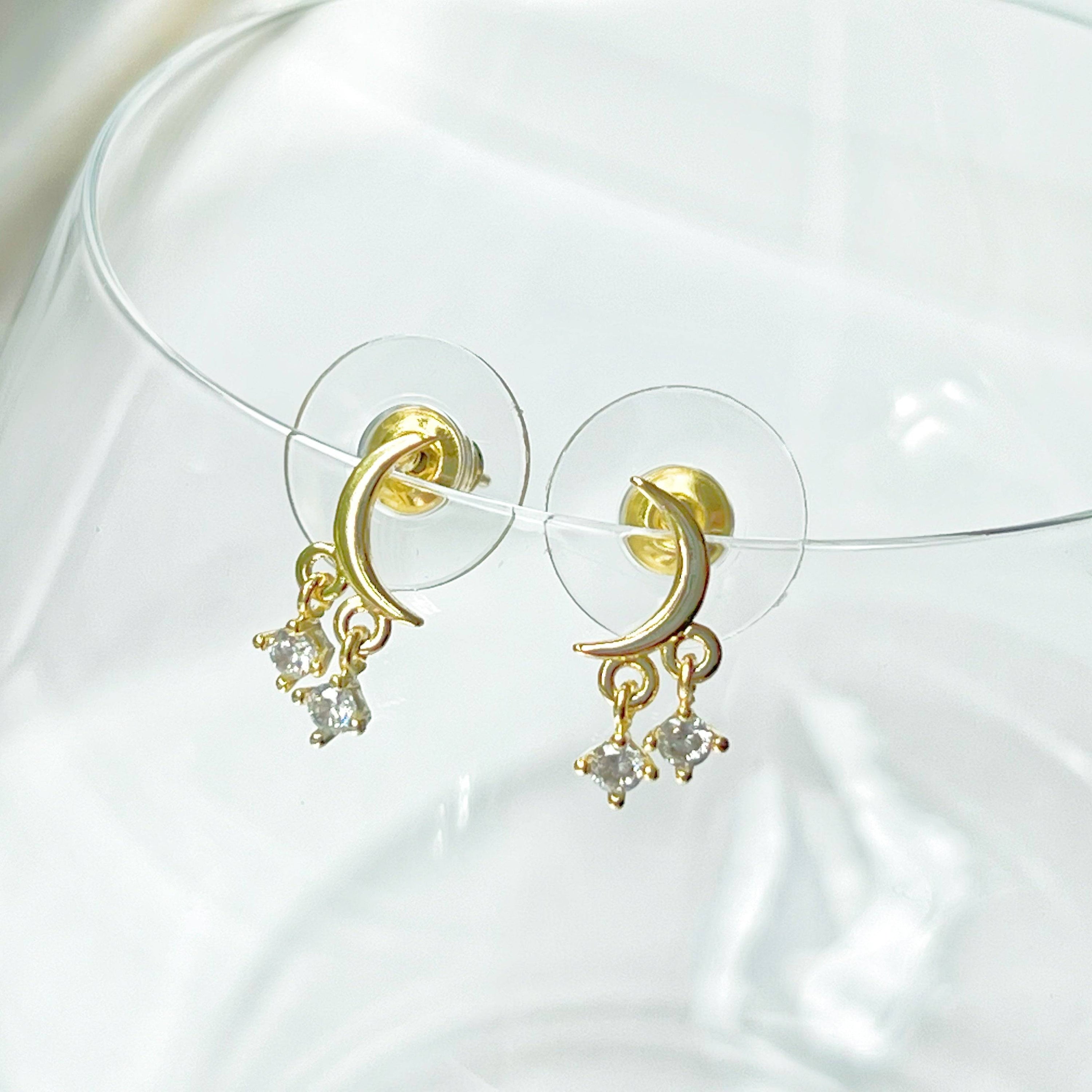 A pair of elegant Little Half Moon Earrings made from sterling silver with gold plated bronze and zircon crystals, symbolizing good luck.