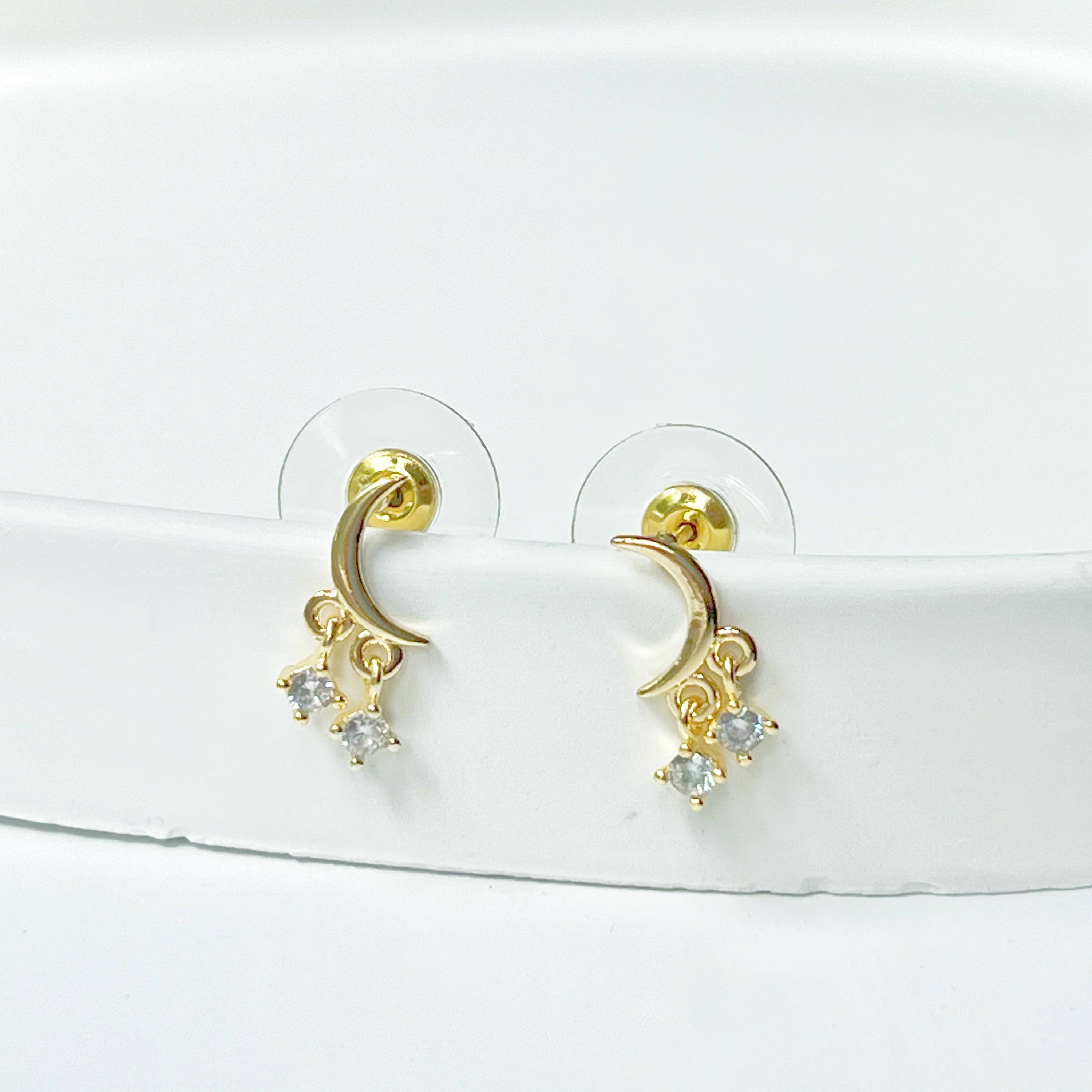 A pair of elegant Little Half Moon Earrings made from sterling silver with gold plated bronze and zircon crystals, symbolizing good luck.