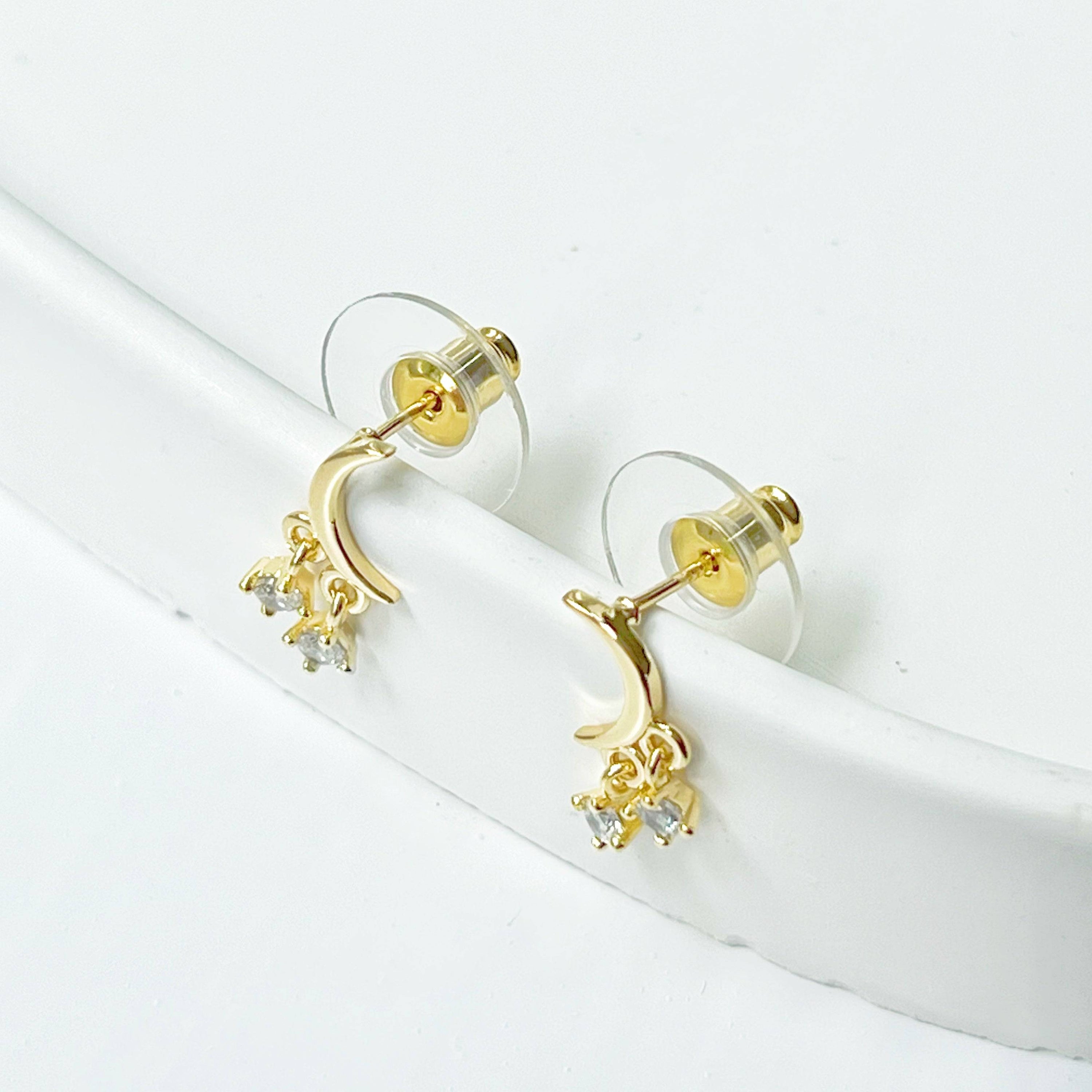 A pair of elegant Little Half Moon Earrings made from sterling silver with gold plated bronze and zircon crystals, symbolizing good luck.