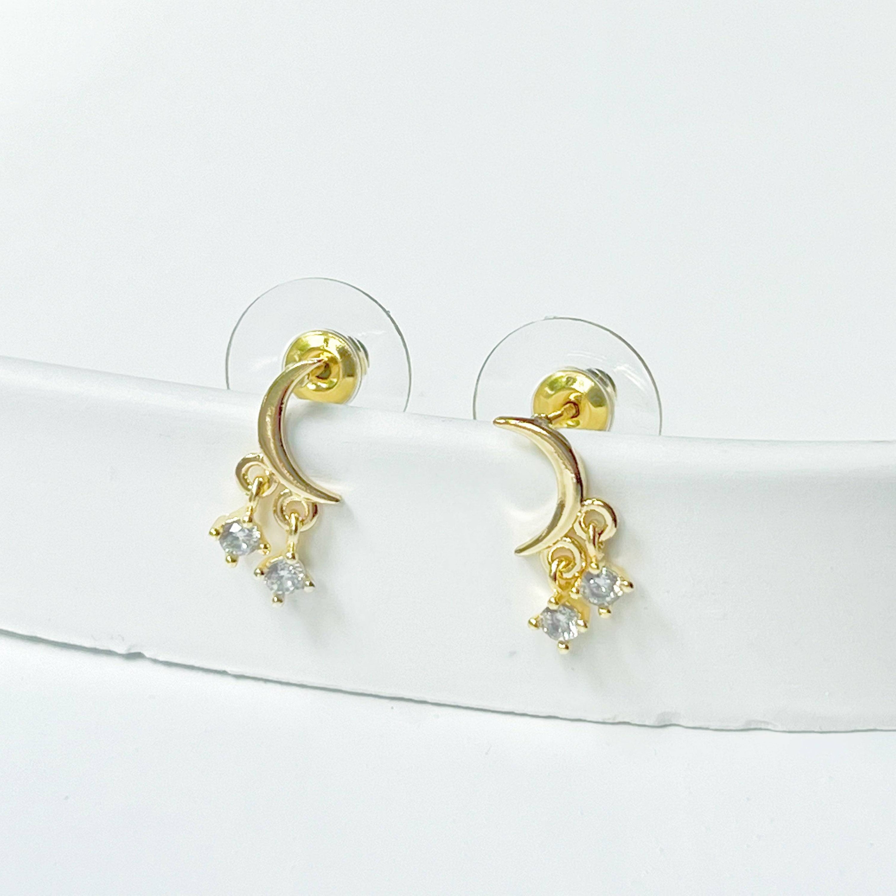 A pair of elegant Little Half Moon Earrings made from sterling silver with gold plated bronze and zircon crystals, symbolizing good luck.