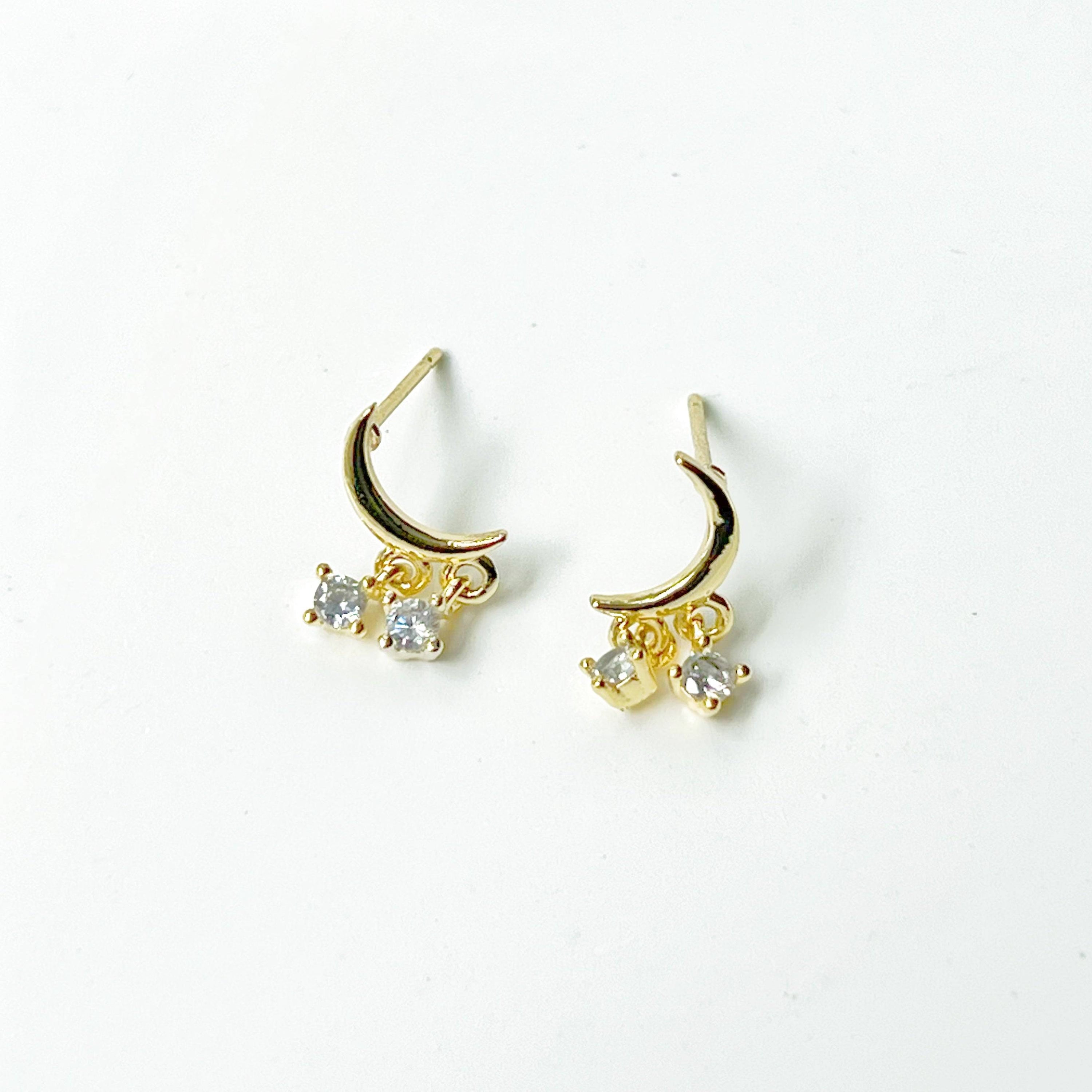 A pair of elegant Little Half Moon Earrings made from sterling silver with gold plated bronze and zircon crystals, symbolizing good luck.