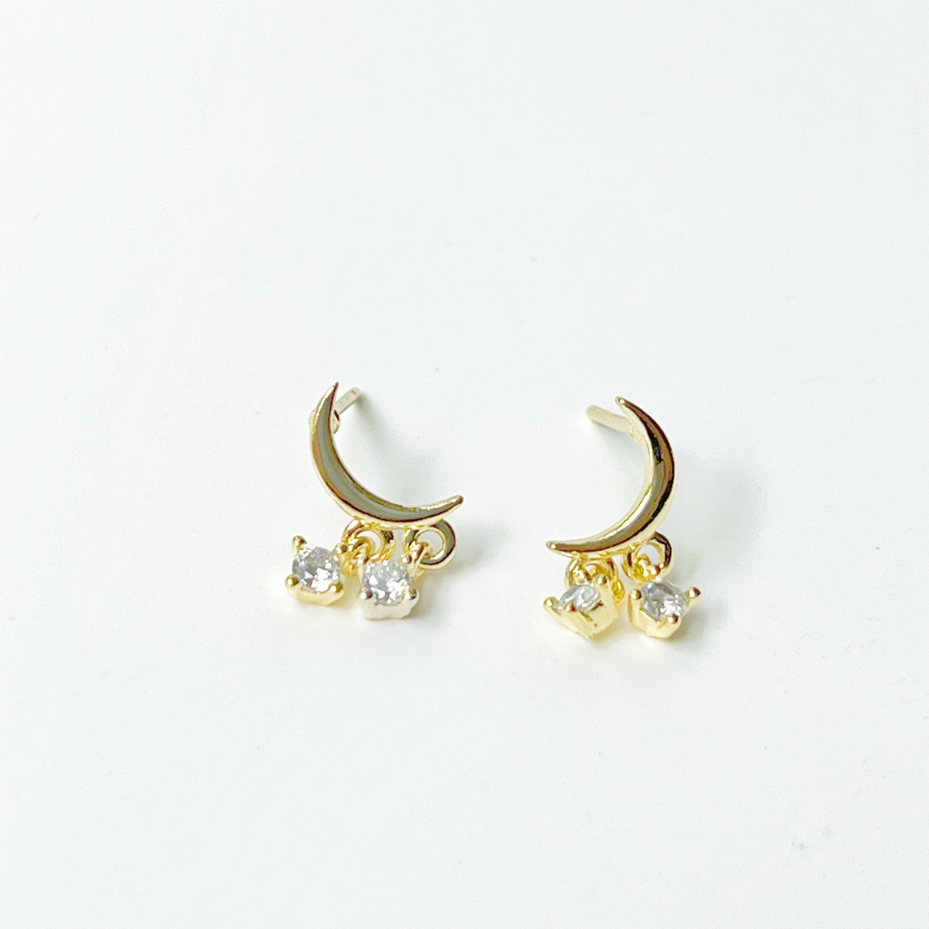 A pair of elegant Little Half Moon Earrings made from sterling silver with gold plated bronze and zircon crystals, symbolizing good luck.