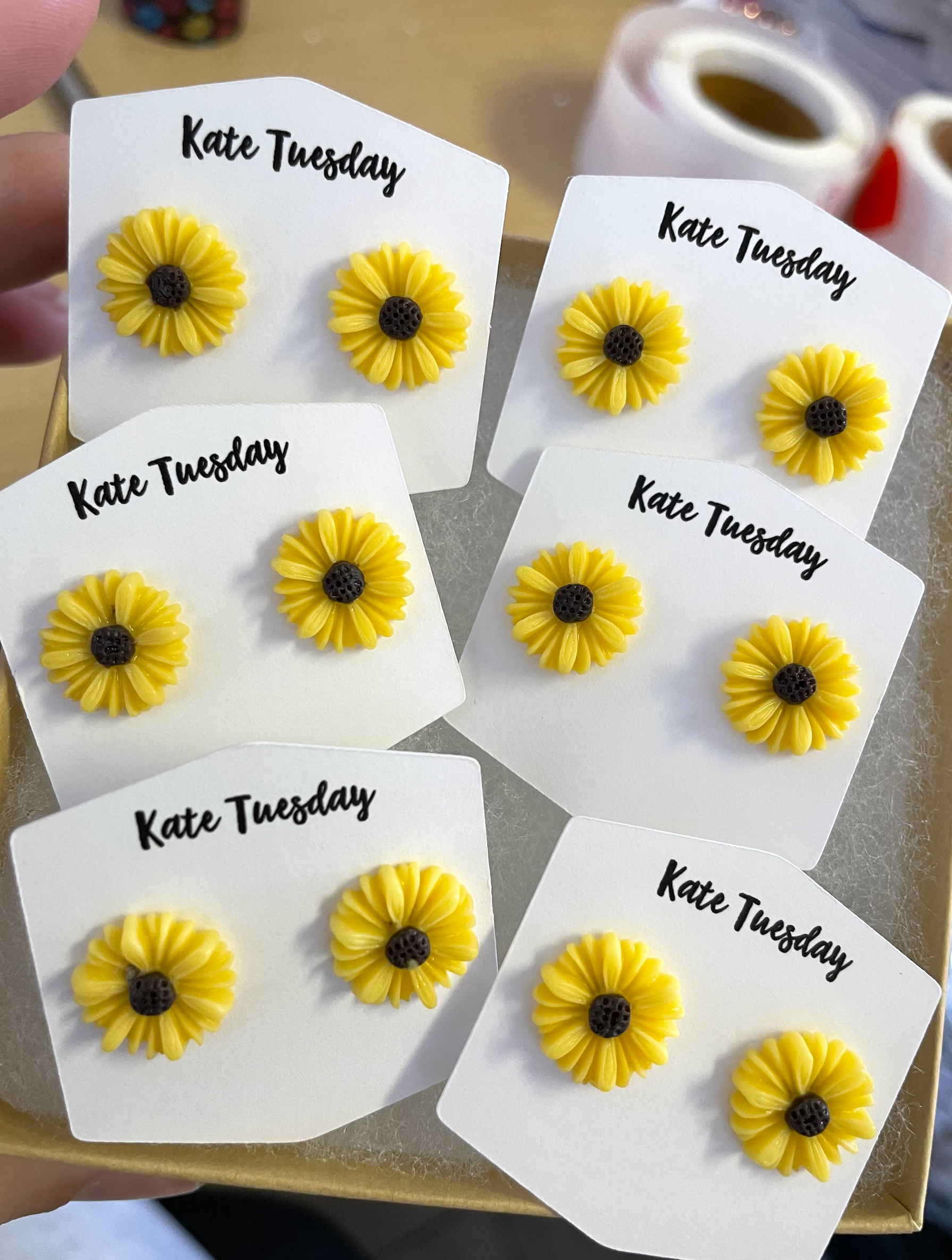 A pair of charming little yellow sunflower stud earrings, featuring a vibrant floral design, perfect for adding a touch of cheer to any outfit.